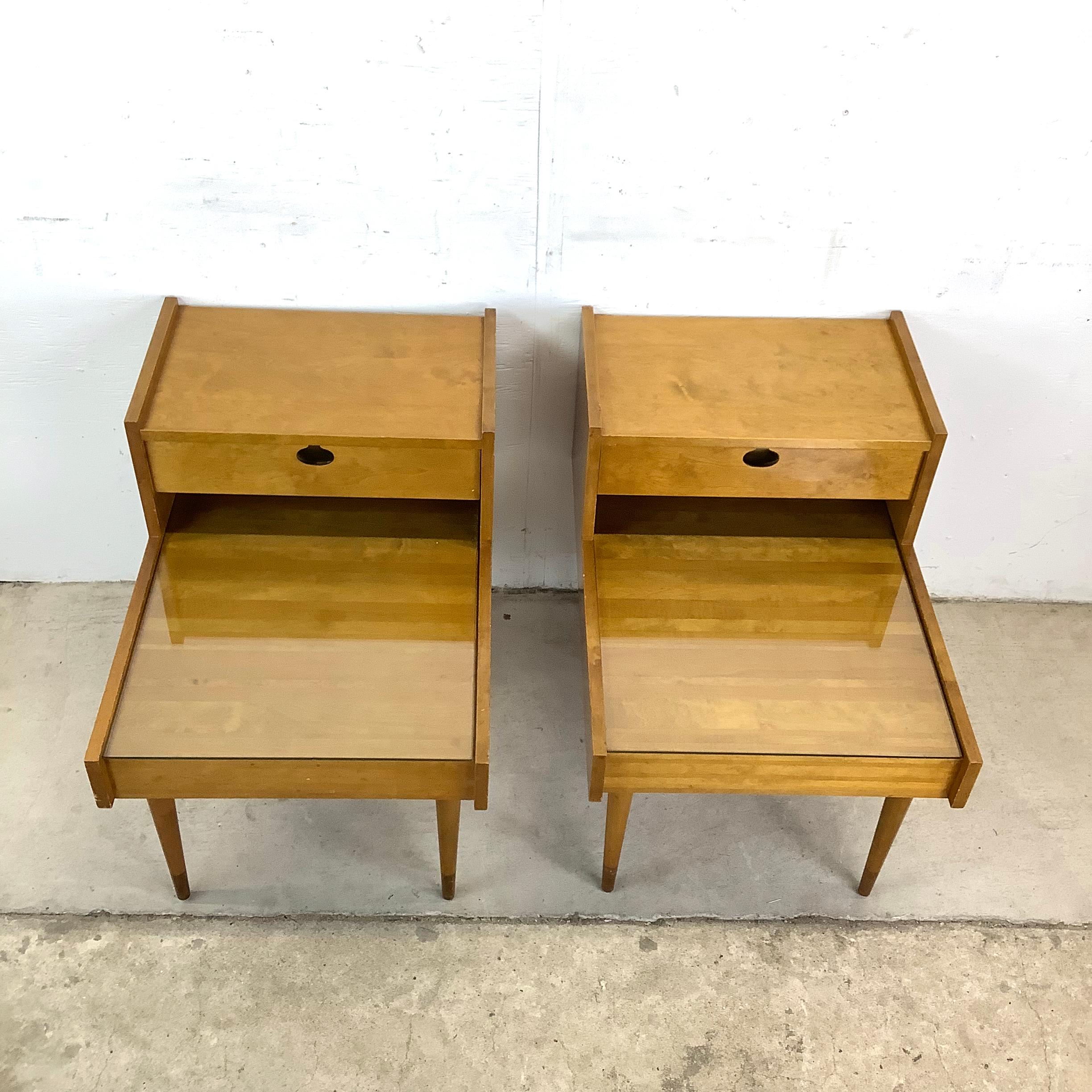 This striking pair of Edmond J. Spence nightstands brings a perfect balance of mid-century modern design and Swedish craftsmanship. Made in Sweden with a beautifully warm birch finish, these pieces feature a two-tier design that enhances both