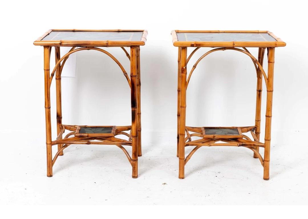 Pair Of Two Tier Bamboo Tables with lower shelf on each. Tropical design on top and on shelf below. Good overall sturdy condition with slight losses to finish. Can be shipped UPS, message with zip code for shipping price.