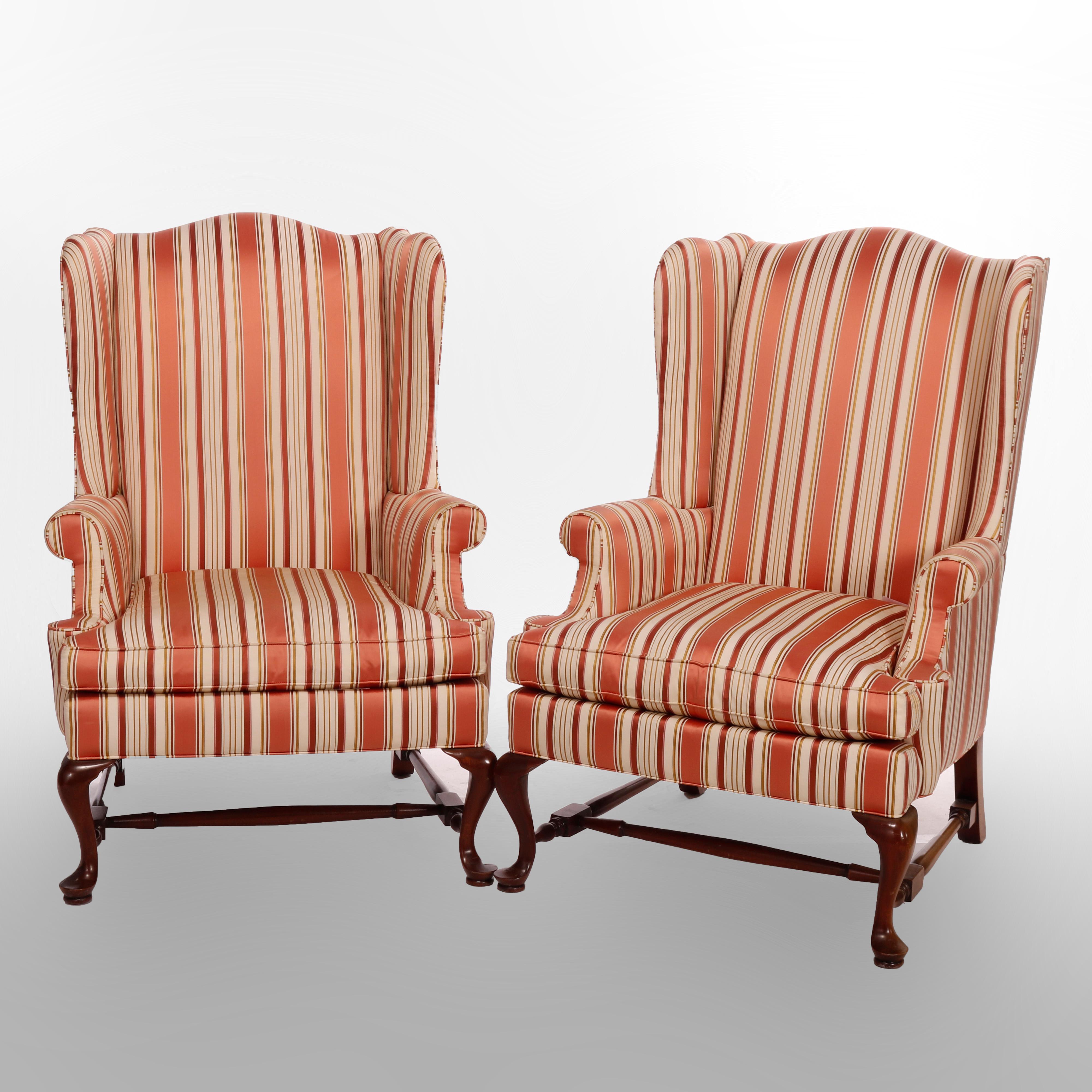 A pair of fireside chairs by Southwood offer wingback form with striped upholstery and raised on cabriole legs with pad feet, maker label as photographed, Hickory, NC, 20th century

Measures - 43.75'' H X 31'' W X 34'' D.