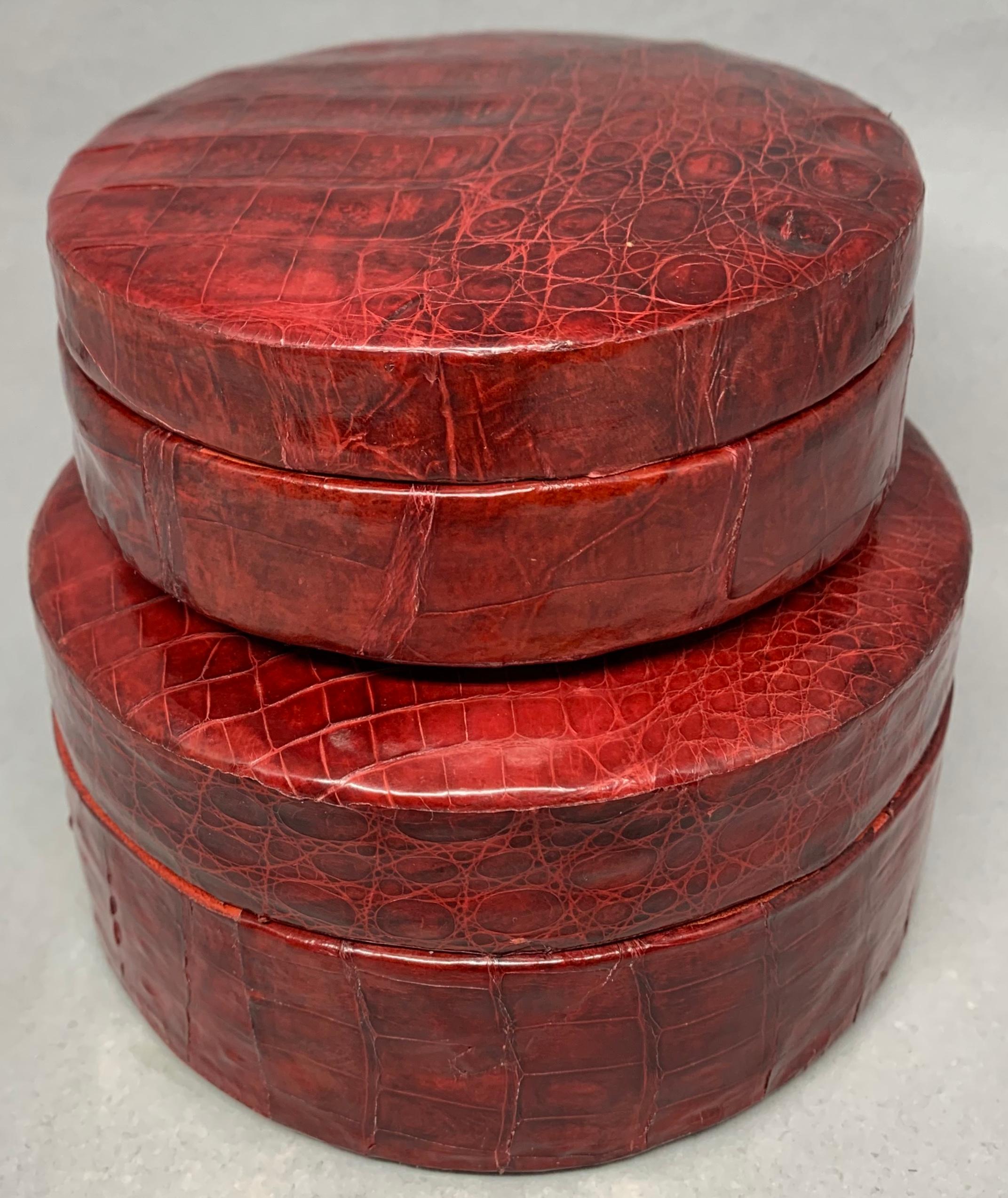 Pair red crocodile nesting boxes. Set of two vintage one of a kind rich carmine red crocodile leather handmade jewelry boxes nesting one inside the other with red velvet linings. Italy, circa 1970
Dimensions: Large box 5.25