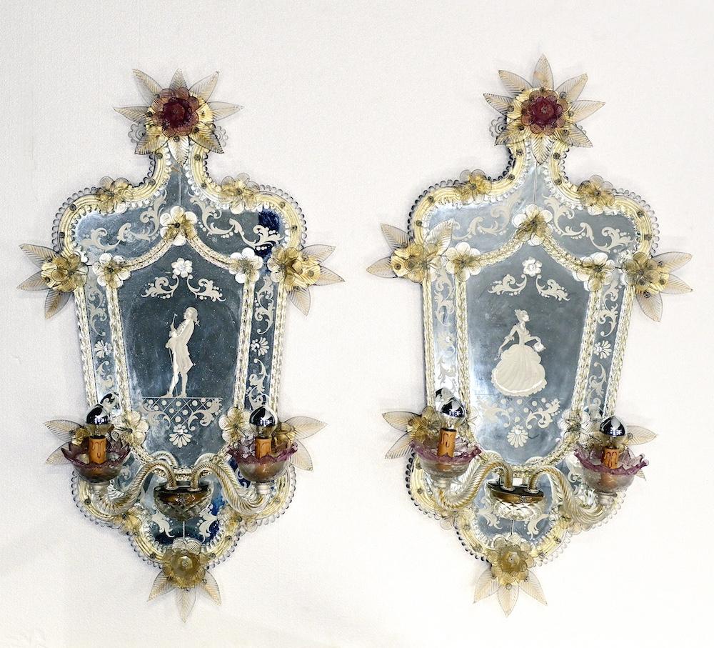 Sought after pair of Italian Venetian glass mirrors
Actually a pair of girandoles as they features two lights to each mirror
Intricate hand etched details including the man and lady - both elegantly dressed - on each panel
Decorated further with