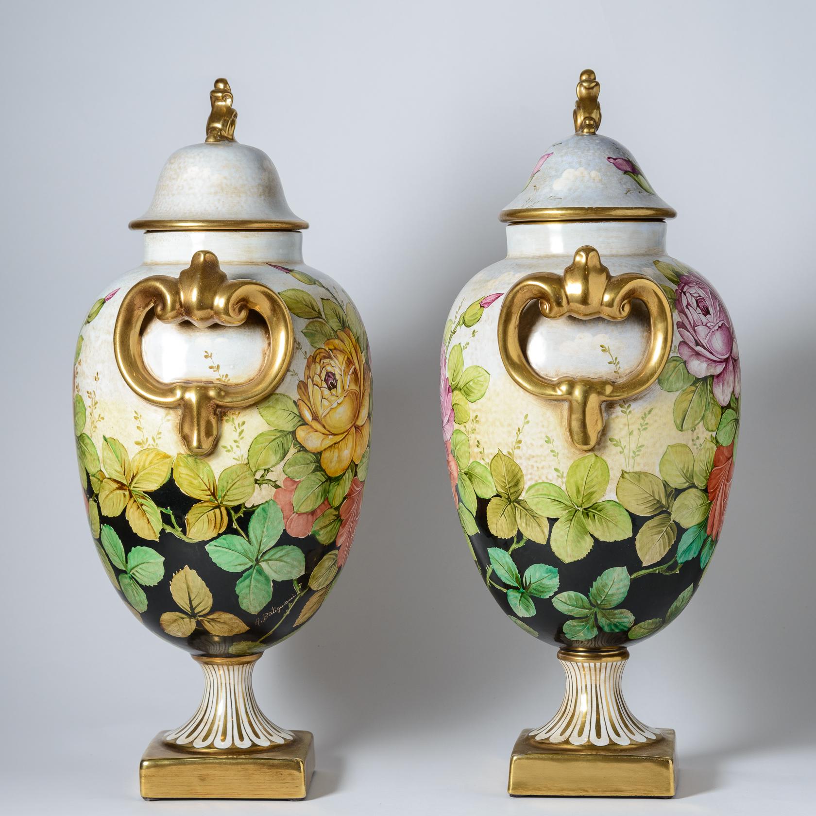 A pair of tall vibrant Italian vases with beautiful covers and unique finials with multi color roses. This pair also features traditional gilt striped bases. Artist signed and with so much detail in the paintings. From a limited edition of 100 only.