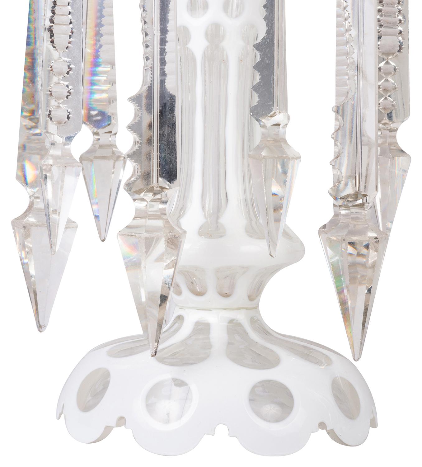A very decorative good quality pair of late 19th century Bohemian cut glass lusters, each with facetted drops and white overlay decoration.