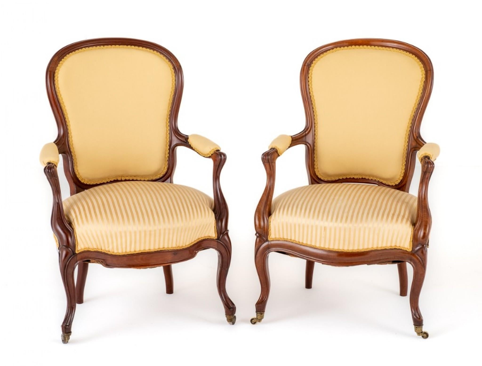 Pair of Victorian Rosewood Open Armchairs.
Raised upon Cabriole Front Legs with Brass Castors and Swept Back Legs.
Circa 1870
Having a Shaped Frieze Rail and Carved and Shaped Arm Supports.
The Arms being of a Padded Form.
The Chairs Having a Wood