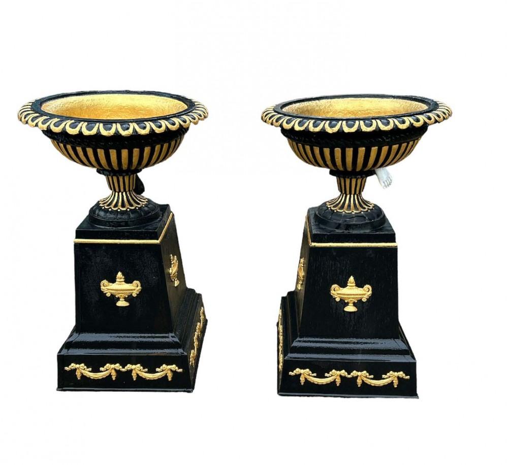 Distinctive pair of Victorian cast iron garden urns or planters
Finished in black with gilt touches included the classical urns on the squared pedestal bases
Would look great with flowers overflowing from the bowls Good size at almost three feet