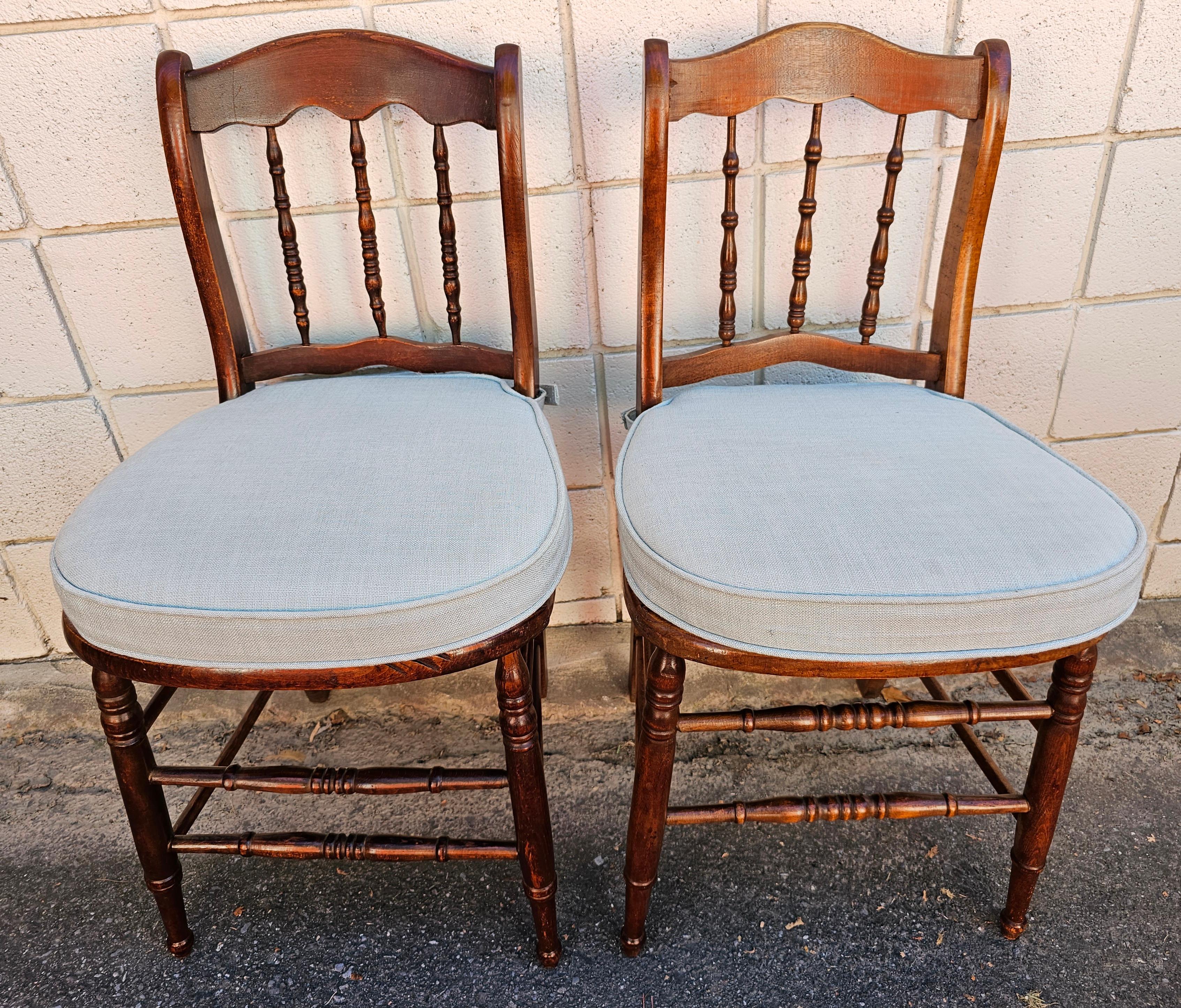 Pair of Victorian Mahogany Spindle back and Cane Seat Side Chairs with Custom Cushion in good antique condition. Custom zippered cushions ( blue sky) in good condition. They attached to the chairs with velcro. Faux Cane Seat are in great shape.