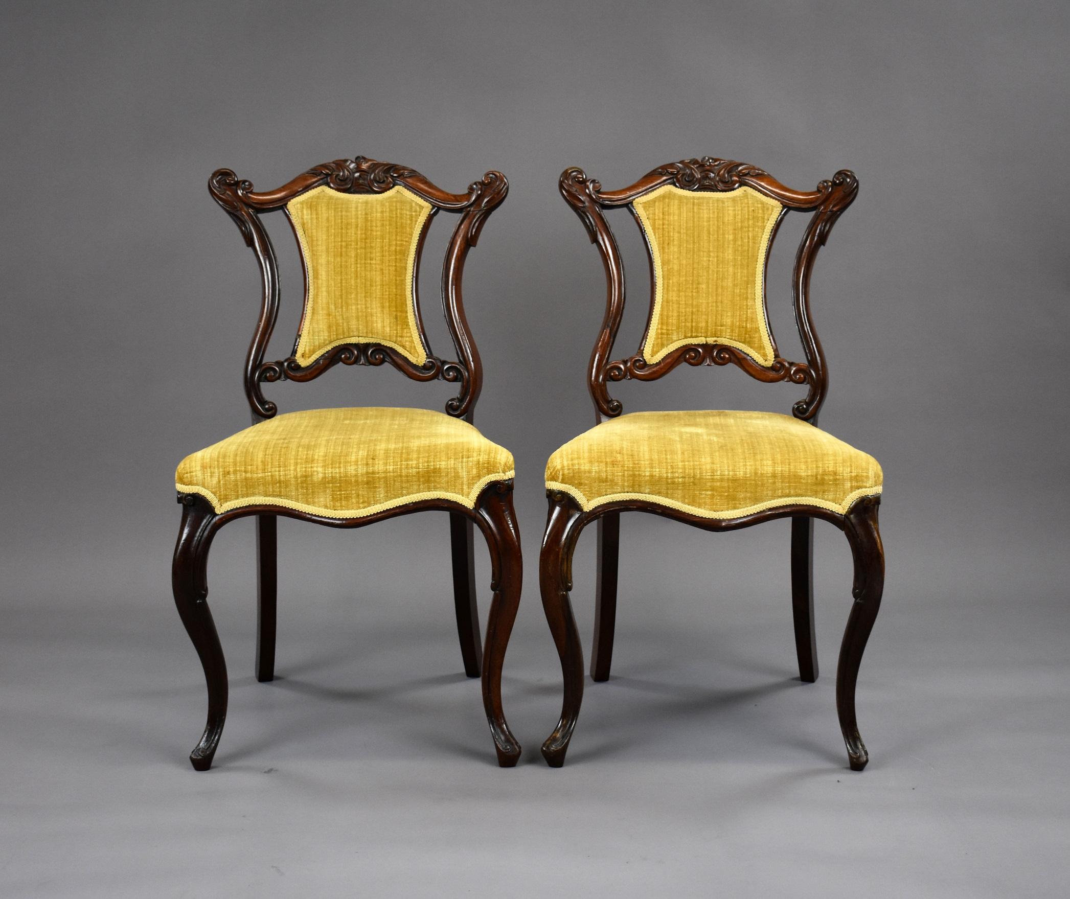 Pair of good quality Victorian rosewood upholstered chairs in good condition having nicely carved backs standing on cabriol legs.