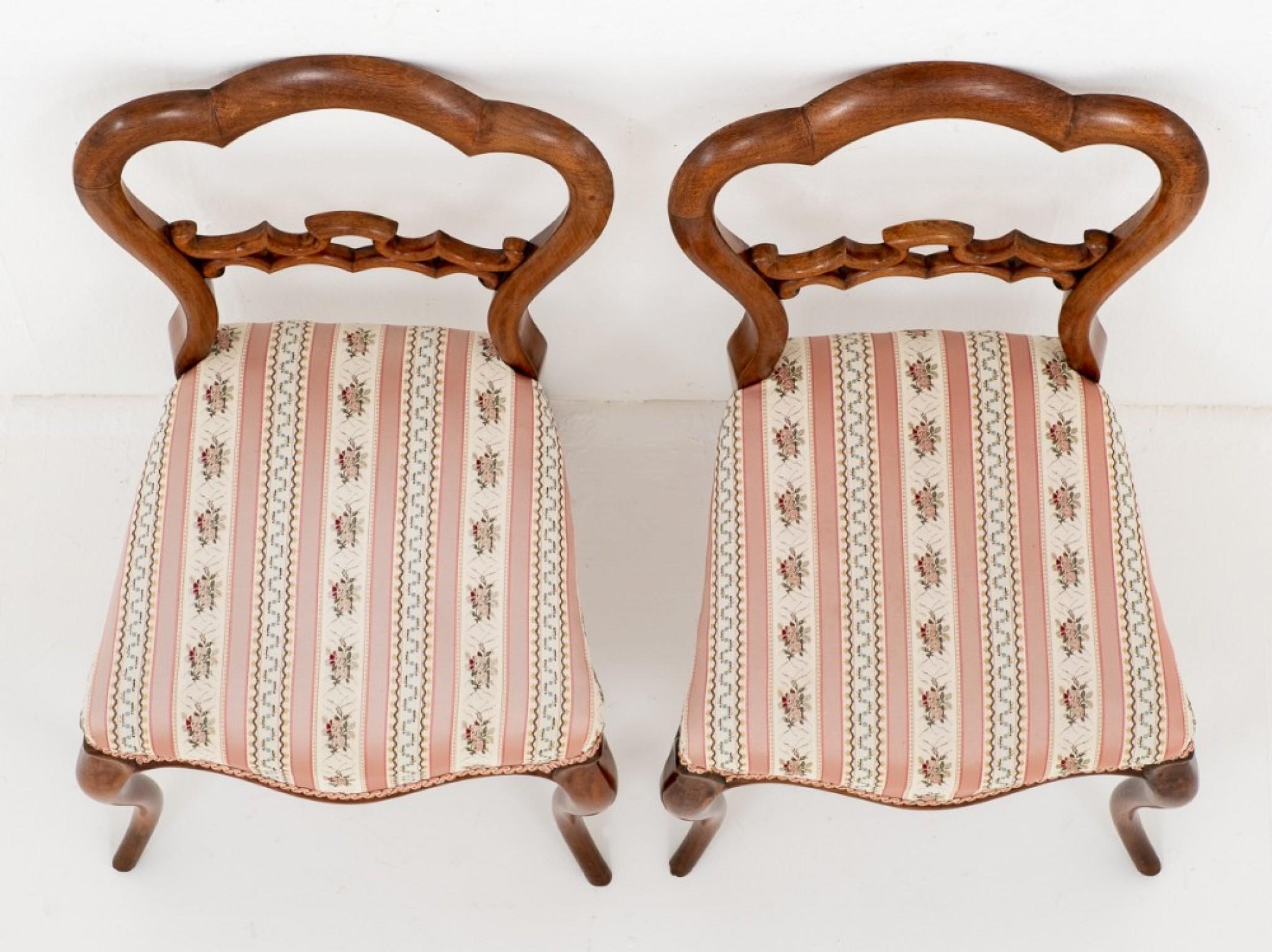 Pretty Pair of Victorian Mahogany Side Chairs.
circa 1860
Each Chair Standing on Elegant Cabriole Front Legs and Sabre Back Legs.
The Chairs Having Stuff over Seats covered in a pretty pink fabric.
The backs of the chairs Feature a Carved and