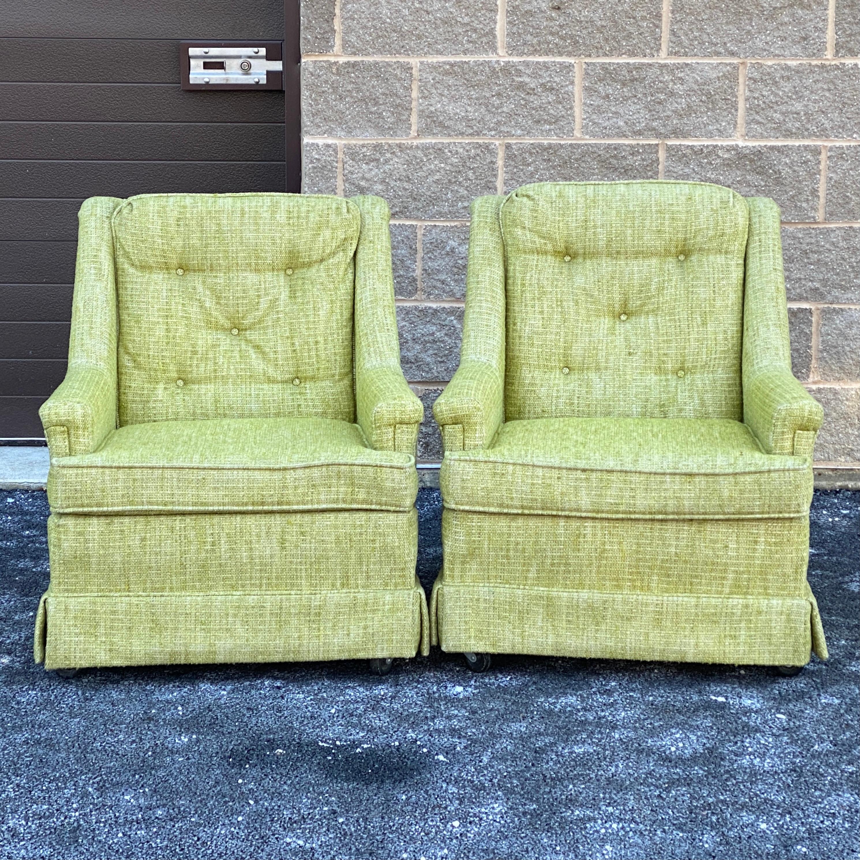 Vintage Flexsteel lounge chairs in original light green woven upholstery with five button backs, loose seat cushions and skirted base. This model has caster front legs for mobility paired with tapered rear legs. Each retaining the original Flexsteel