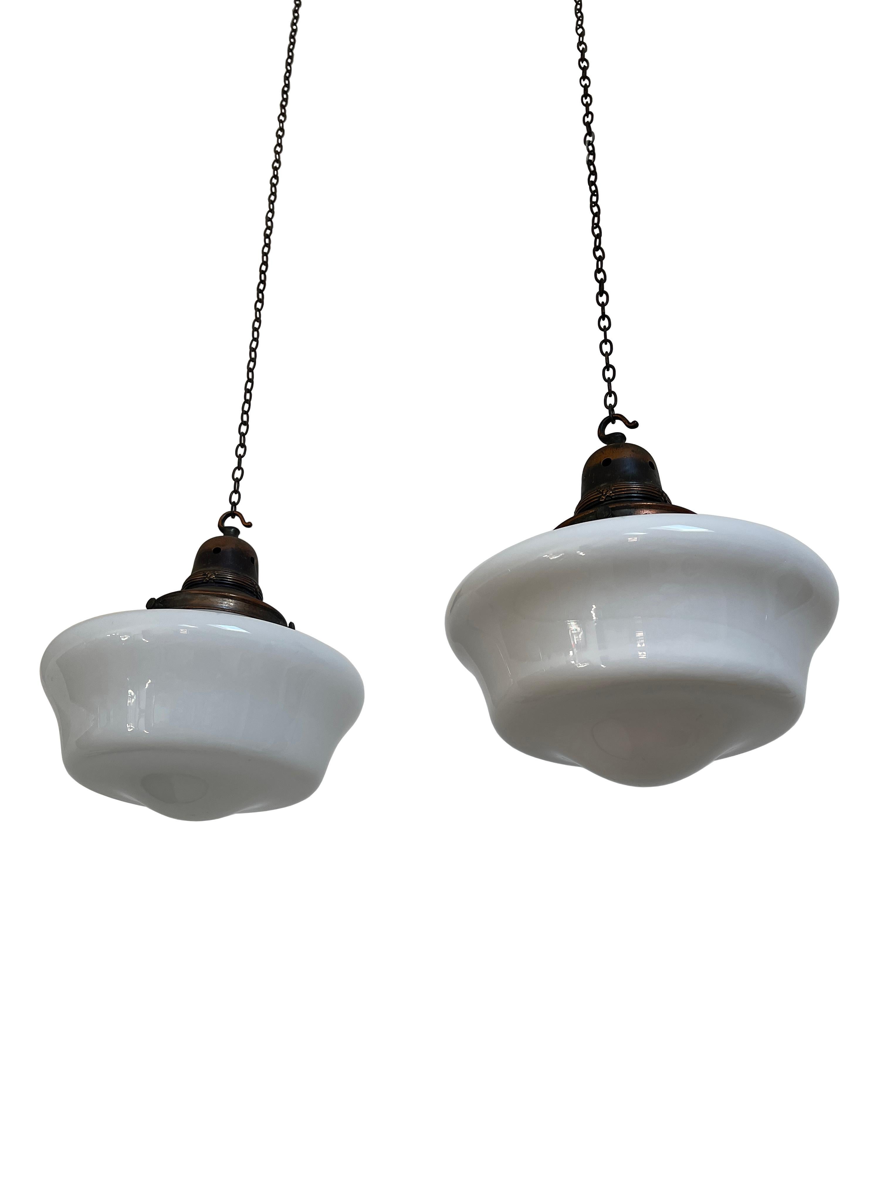 - A fabulous pair of original church opaline glass pendant lights with patinated copper galleries, circa 1930.
- Wear commensurate with age, all in a good condition, the copper galleries are aged worn.
- Rewired with braided flex and PAT