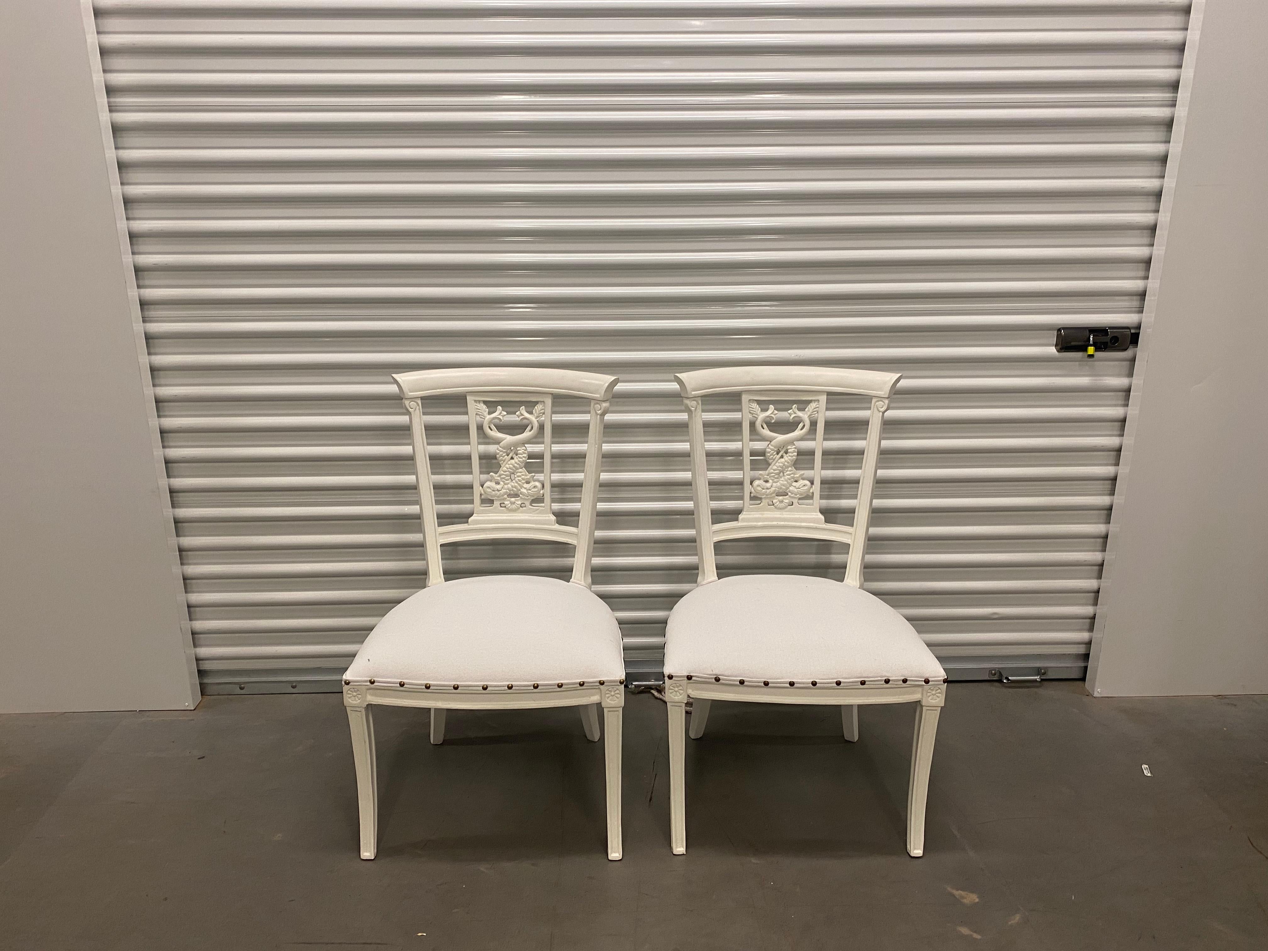 For sale is a fabulous pair of vintage painted side chairs with a wonderful carved dragon design. These are very solid chairs, newly upholstered in a performance fabric with nailhead trim. Pair of chairs came from an antique store in New York City