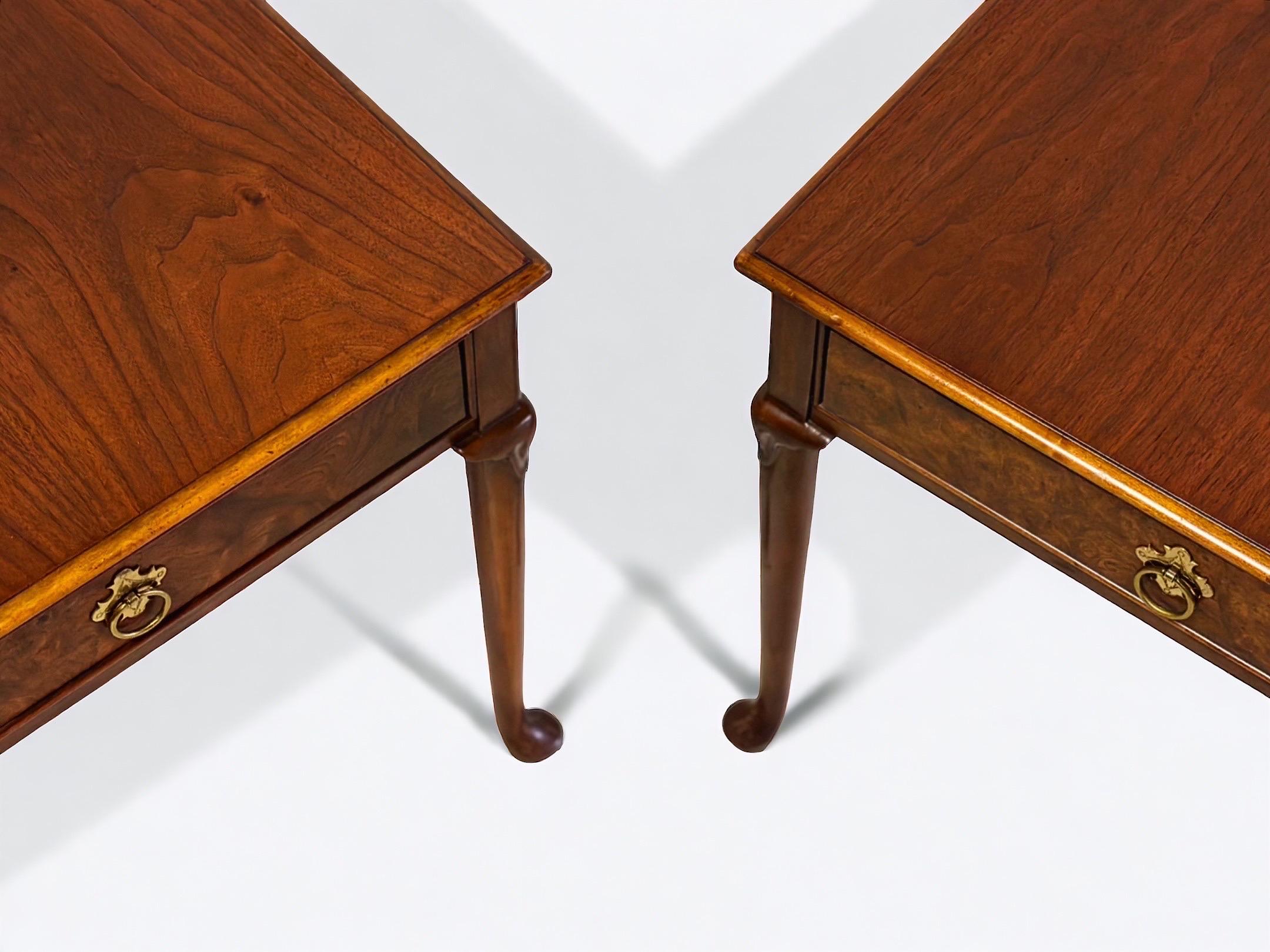 Pair of gorgeous Queen Anne style occasional side or end tables by Baker, circa 1980s. Would also be fantastic as a pair of nightstands.

Walnut, with burled olive wood drawer front and original brass hardware.

Measures: 18