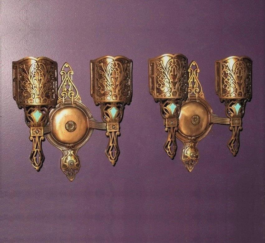 Priced per pair with several pairs available.
Nicely cast bronze double bulb vintage wall fixtures with a Spanish Revival or Tudor feel. . These would actually go well with any of the interiors of their day, including Craftsman, Bungalow, Arts &