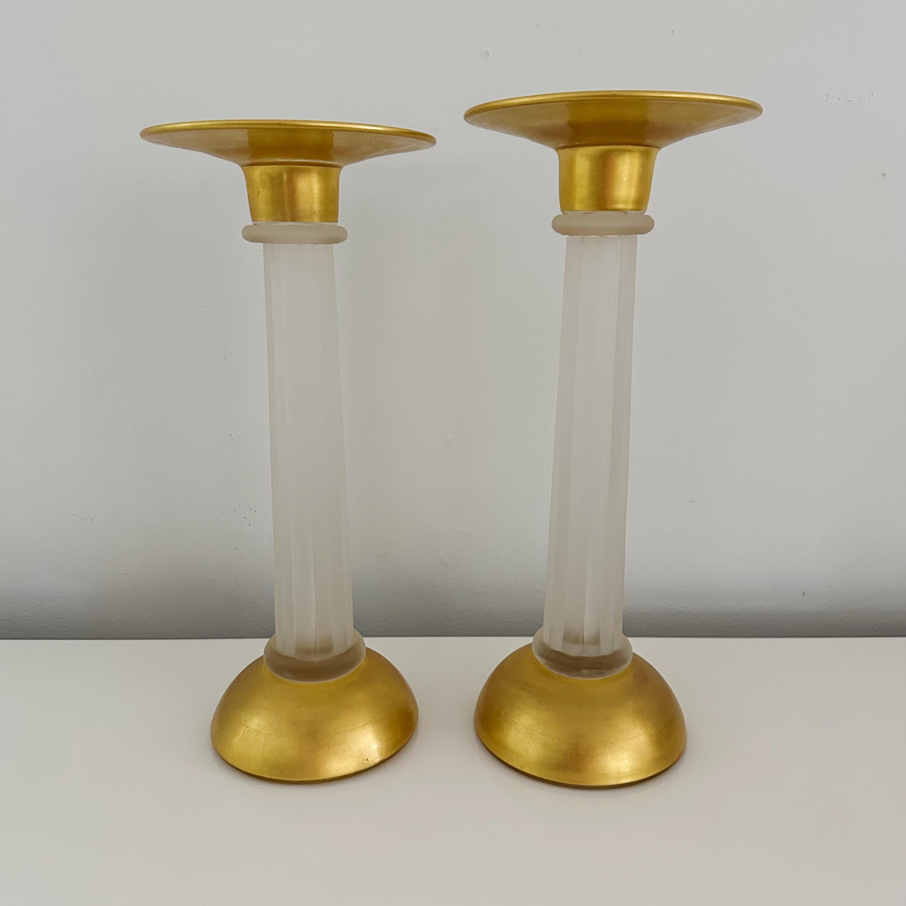 This pair of Murano glass candle holders features translucent fluted stems with exquisite gold leaf tops and bottoms. Each piece is signed on the base with the distinguished name 