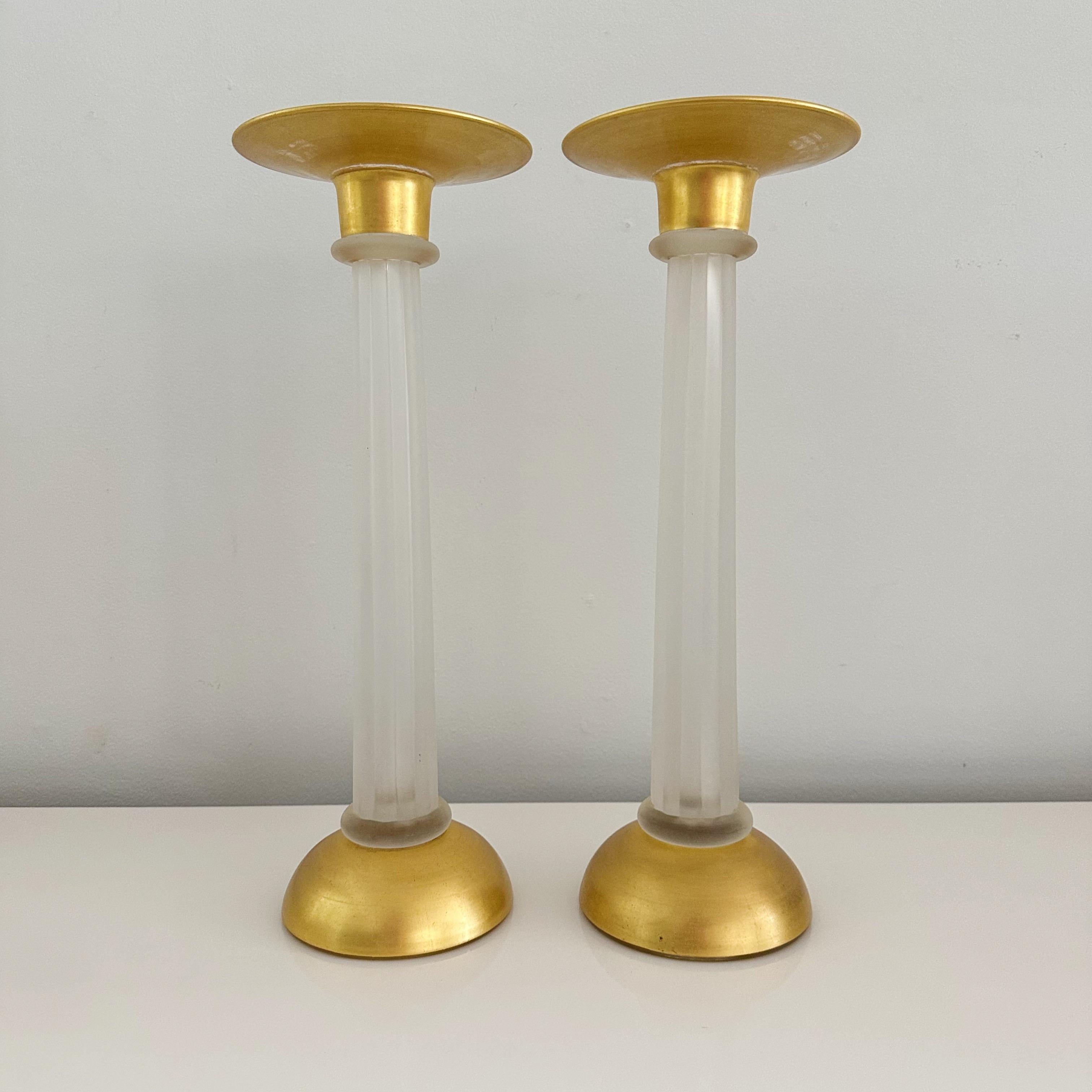 This pair of tall Murano glass candle holders features translucent fluted stems with exquisite gold leaf tops and bottoms. Each piece is signed on the base with the distinguished name 
