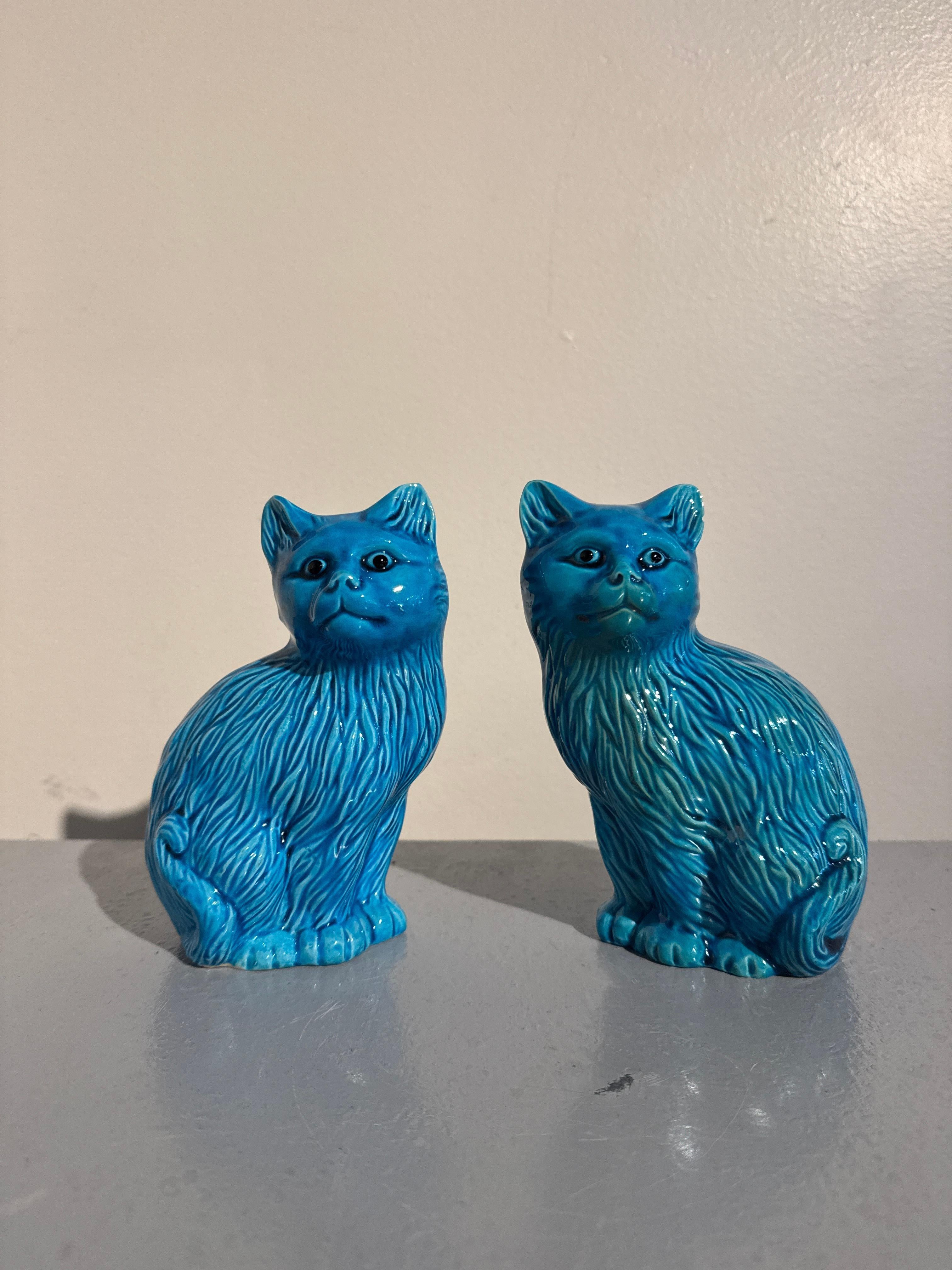 A charming and delightful pair of vintage Chinese turquoise glazed porcelain cats, mid 20th century, China. 

The two felines sit politely upright, inquisitive looks upon their faces, ears perked up and eyes alert. Their coats are wonderfully