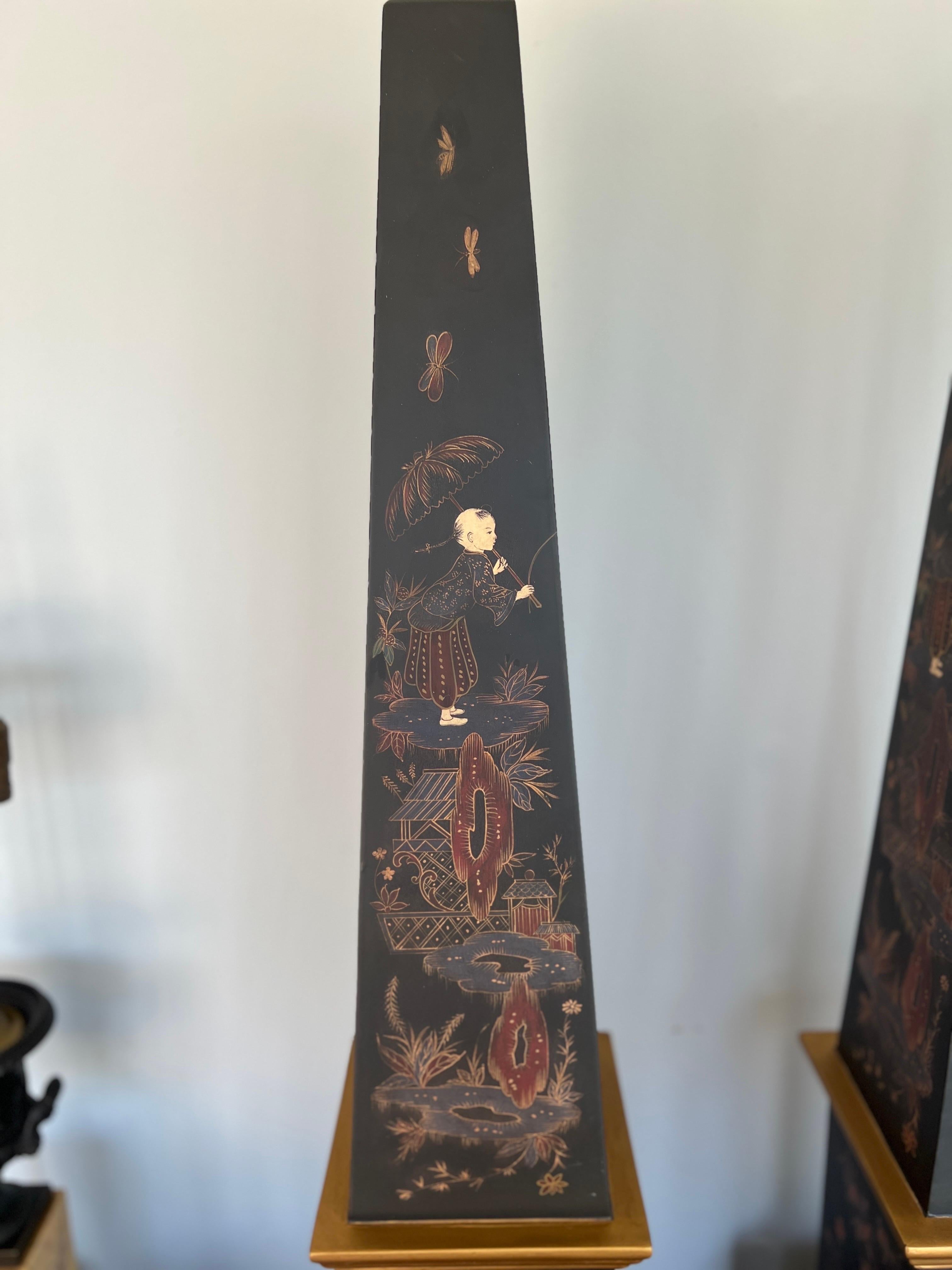 Italian, 20th century.

Introducing a captivating pair of Vintage Chinoiserie & Partial Gilt Wood Decorated Obelisks, each a testament to timeless elegance and artistic finesse. Standing tall and proud, these obelisks exude sophistication with their