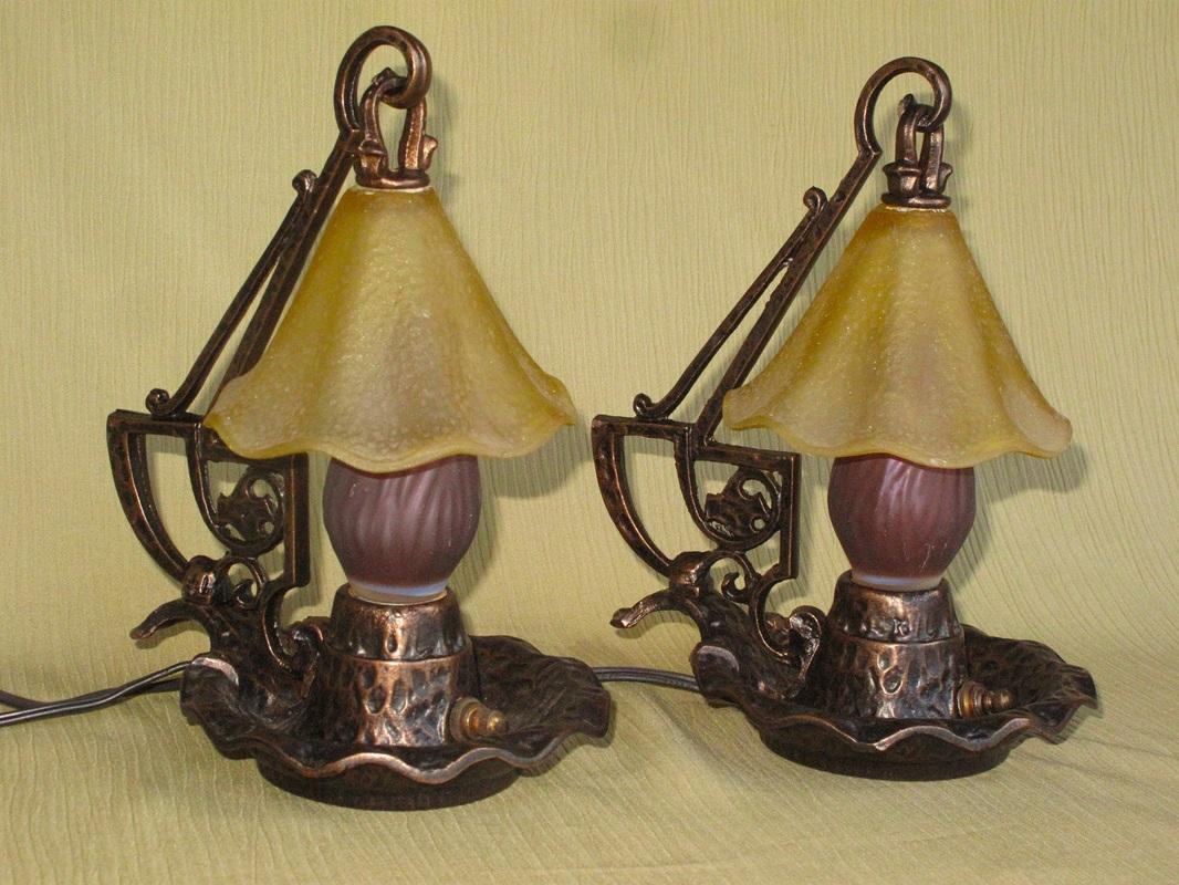 Pair of table or bedside lamps in the Craftsman Style and Arts & Crafts style.
Refinished to match their original color, Sunset Golden. Original shades still grace these wonderful little lamps.
Rewired with new cord, rewired sockets, and new turn