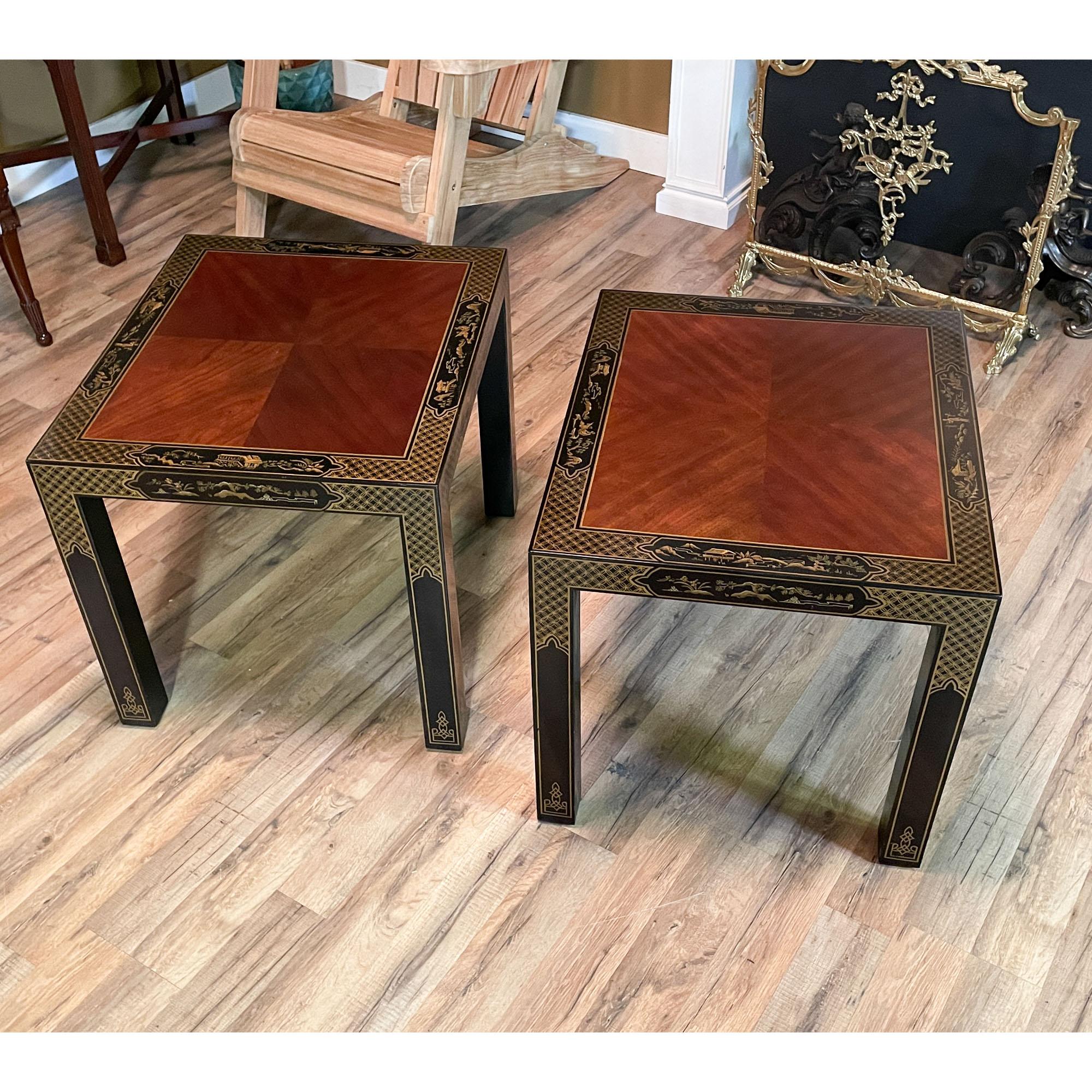 A pair of Vintage Drexel end tables featuring beautifully detailed black lacquerware paint in incredible detail. A fine quality veneered top creates a beautiful pattern, and the edge of which is accented by hand painted details all around on each