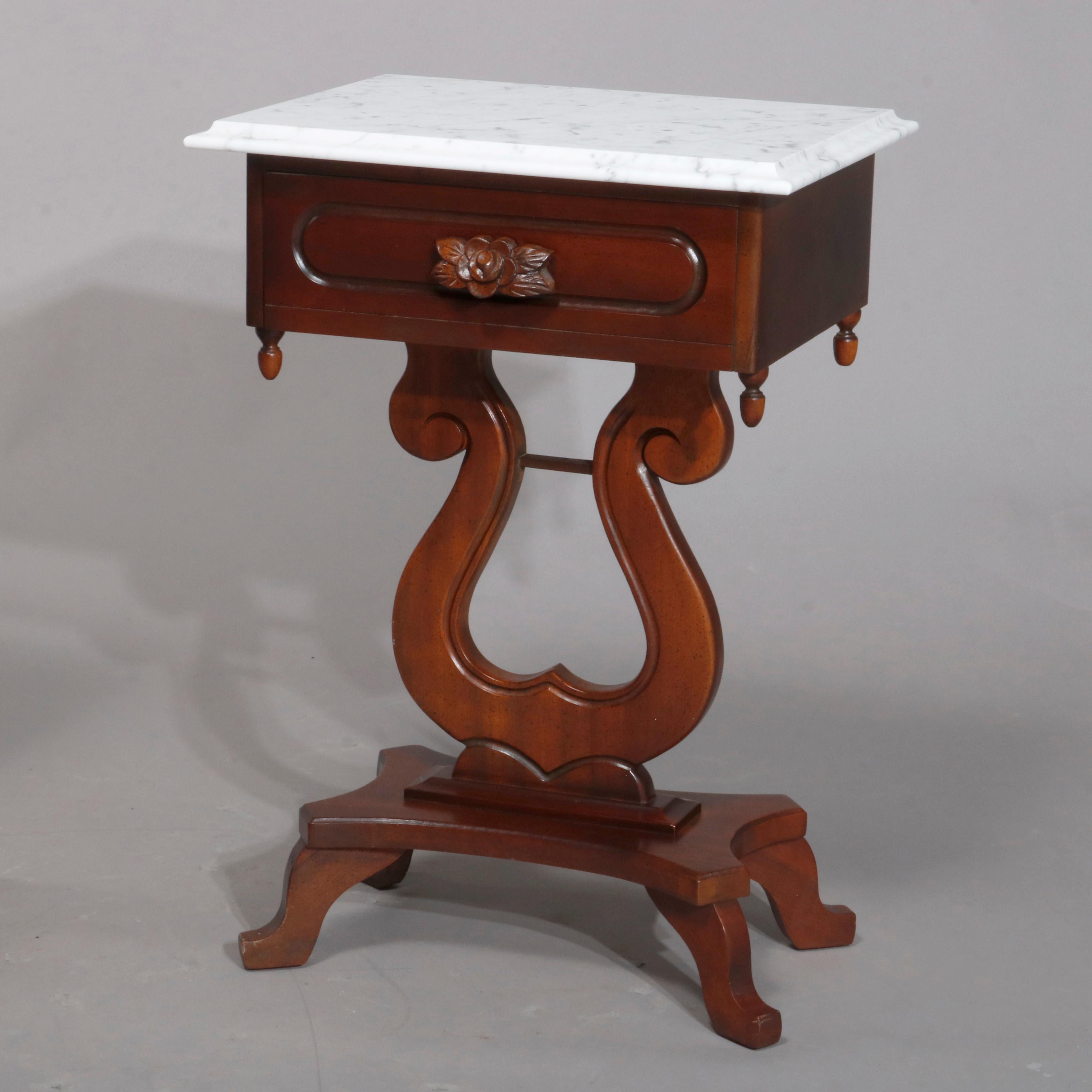 A pair of vintage Sheraton Duncan Phyfe style side stands offer beveled marble tops over mahogany cases with single drawer having carved pull and drop finials surmounting lyre form pedestals seated on base with four feet, 20th century

Measures: