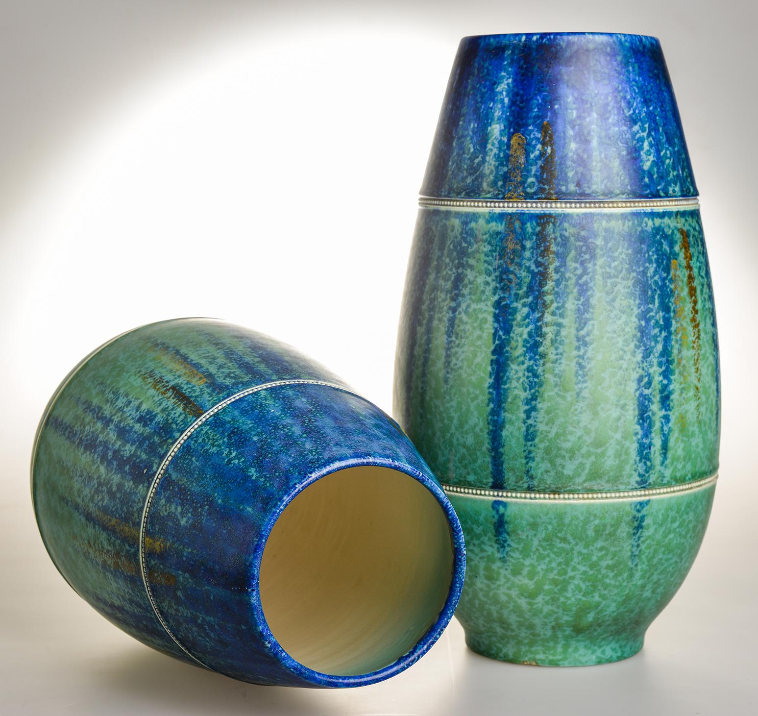Beautiful and modern shape for this pair of vintage English ceramic vases, mottled blue and green ground,
punched 