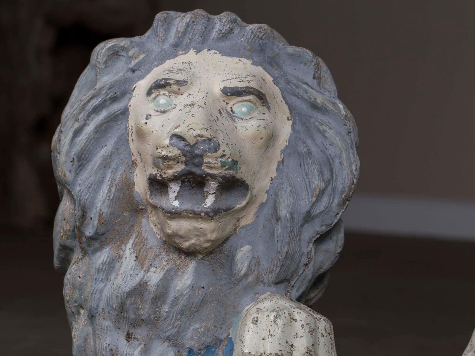 A pair of vintage English French cast stone lion garden ornaments with a painted finish circa 1930. What personality these lads have! Be sure to use the enlarge and zoom functions offered on our website to see the details. Both lions have a