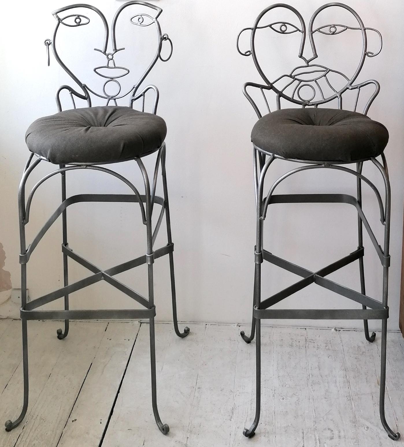 A rare pair of whimsical figural John Risley style dark silver coloured wrought iron bar stools, USA 1970s / 80s. One male, one female ??
With original charcoal seat pads.

Dimensions : width 45cm, depth 46cm, height 114cm, seat height 81cm