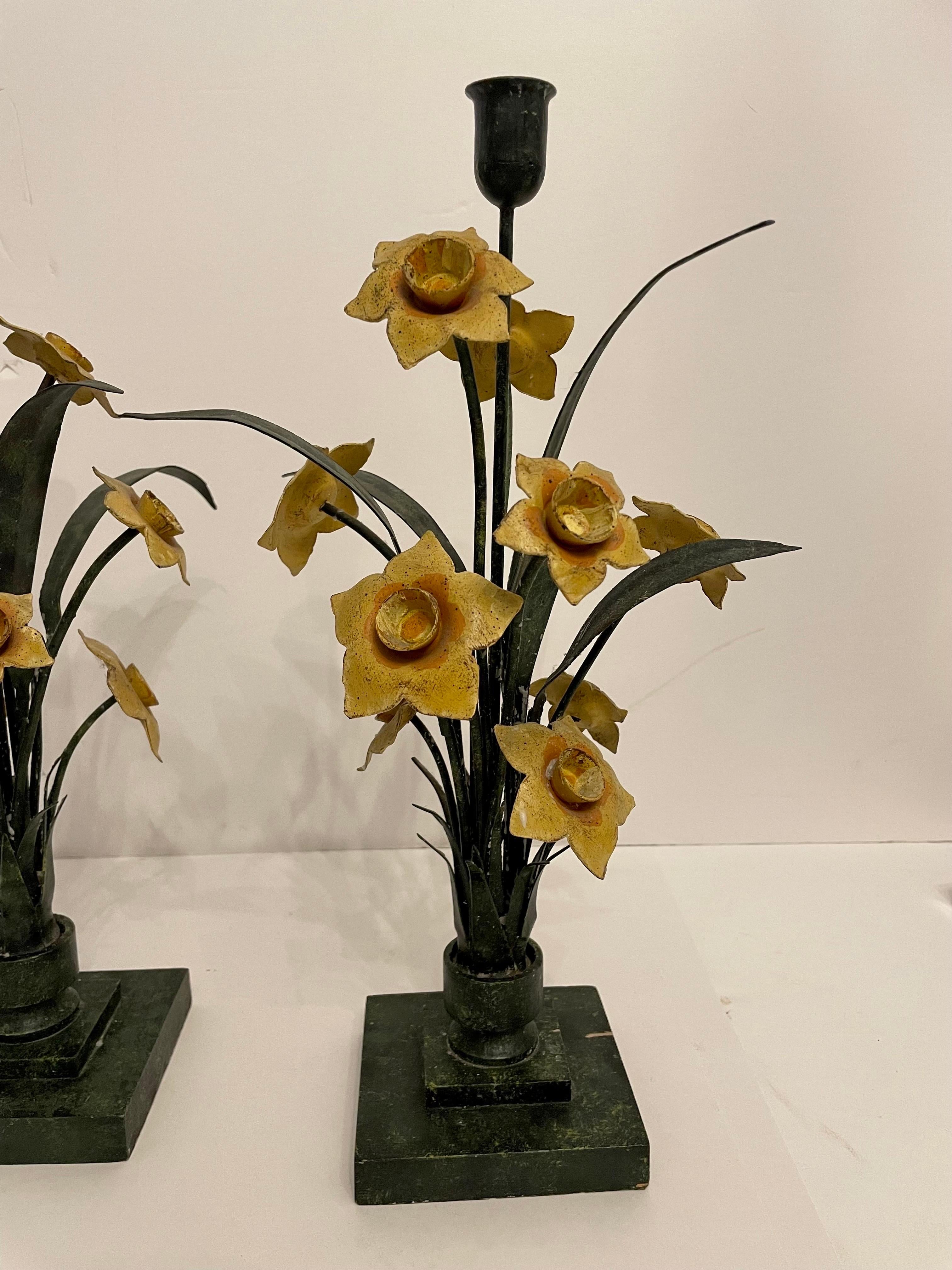 Pair vintage floral Italian tole painted candle sticks on faux marble painted wood bases. Few nicks to painted finish on base from age and use. Holds one candle each. Measures: 16