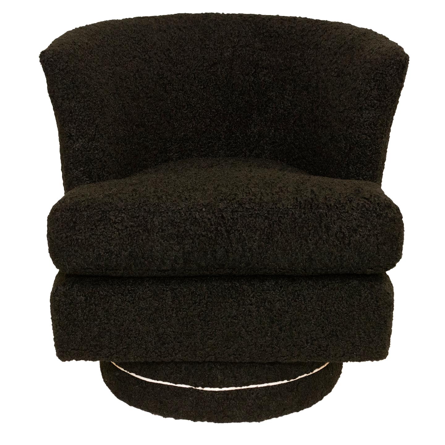 We have updated the upholstered chairs with swivel bases they were originally featured a skirt. They are upholstered in black faux shearling. We designed custom circular wooden bases and they were specifically made for these chairs. They were