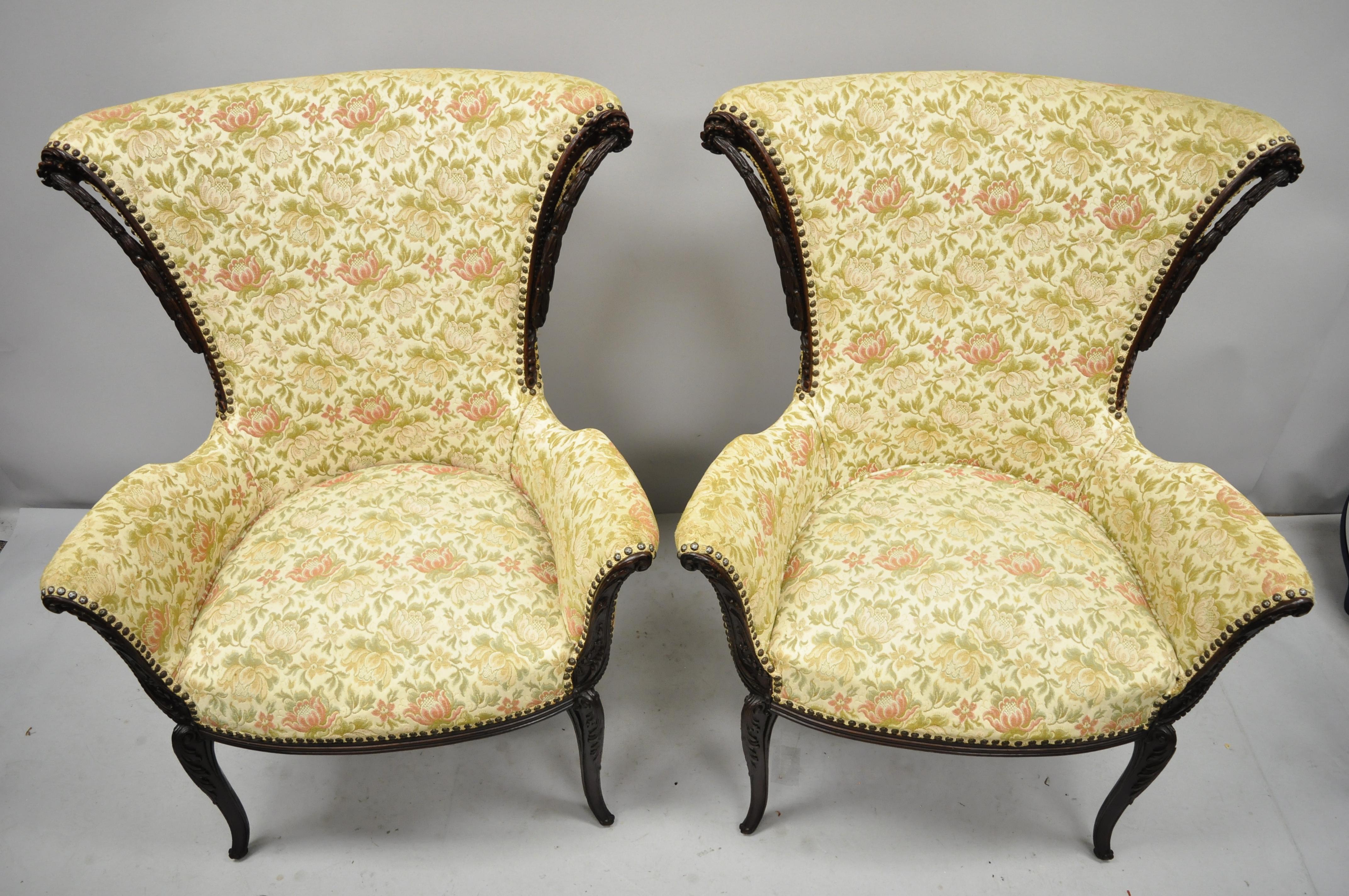 Pair of vintage French Hollywood Regency carved mahogany fireside lounge arm chairs. Items feature solid wood frame, nicely carved details, tapered legs, great style and form, circa early 20th century. Measurements: 41