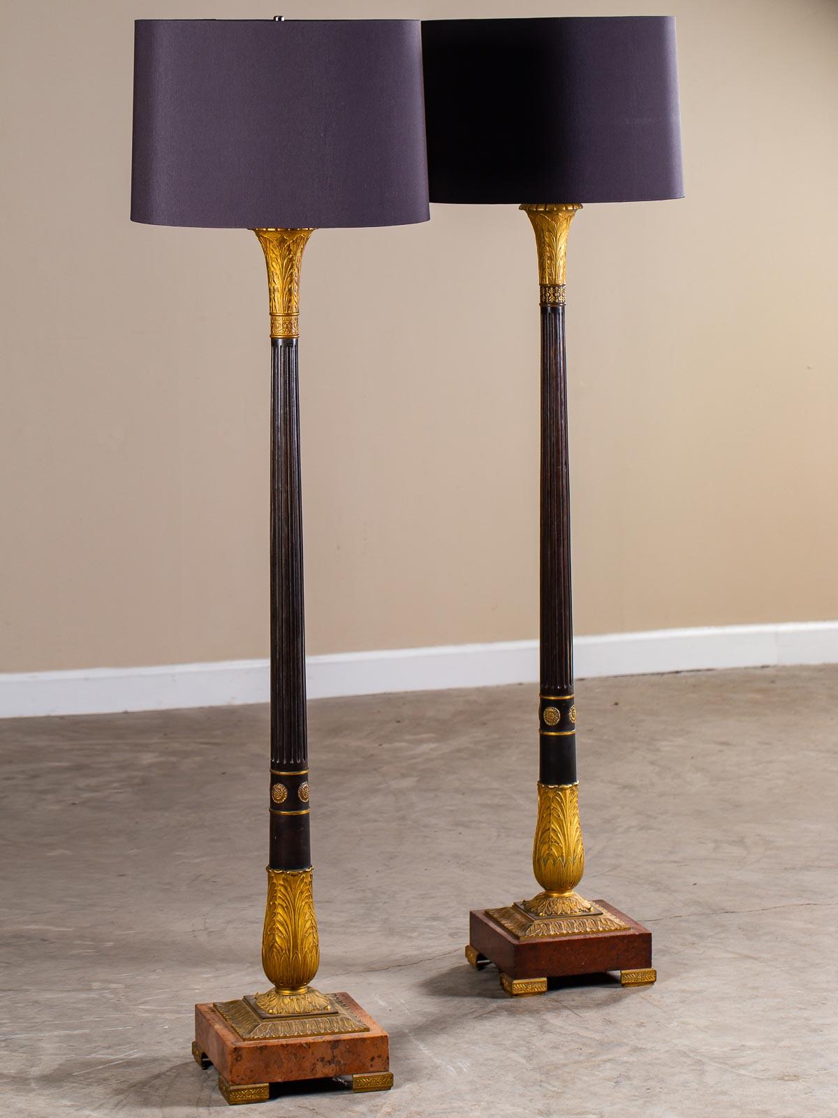 A pair of antique French Neoclassical bronze gilt bronze candlestand floor lamps circa 1900. This pair of French floor lamps has a marvelous amount of detail reflecting the Belle Époque period interest in lavish decoration while taking advantage of