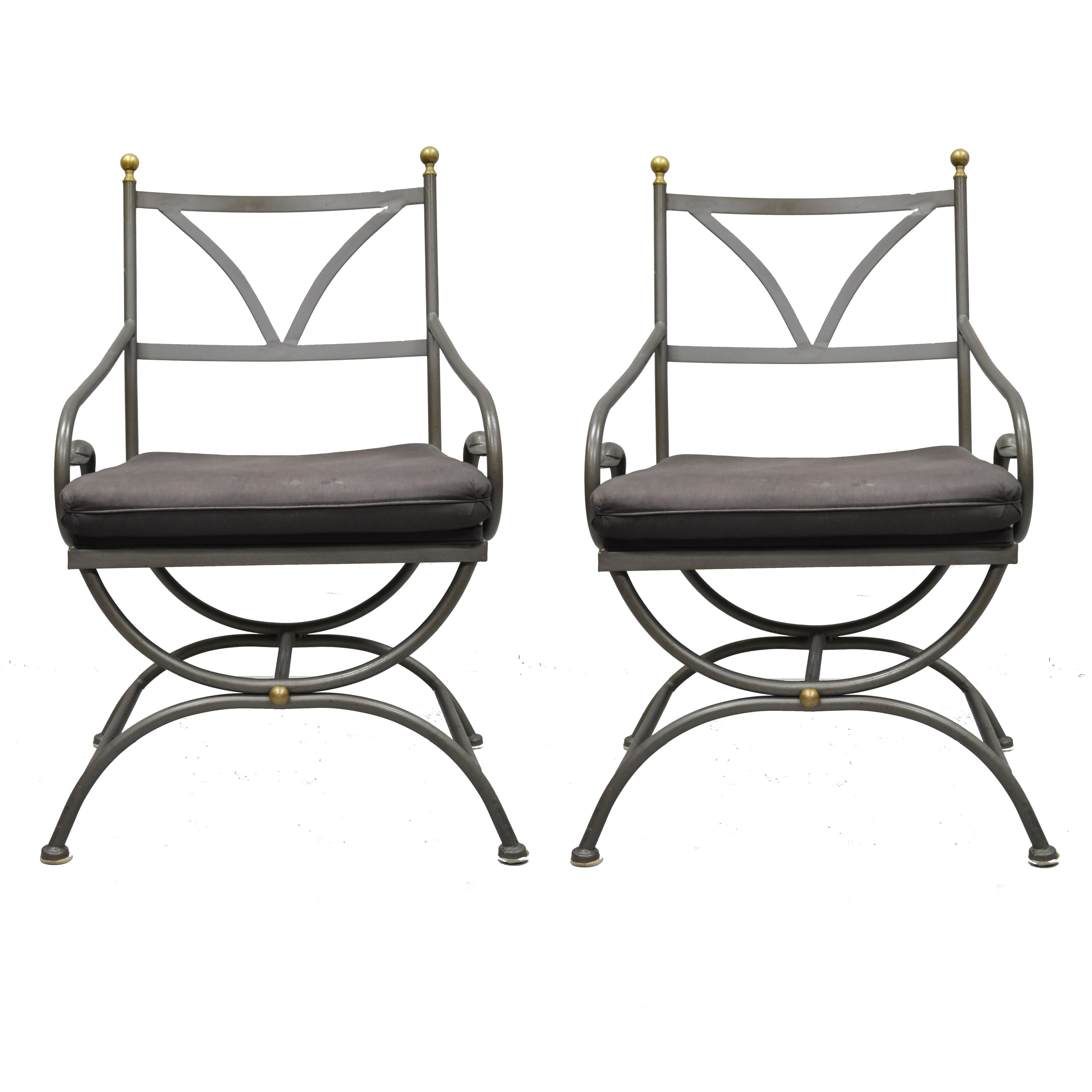 Pair of vintage French Regency style wrought iron Curule frame swan armchairs by Cramco Inc. Chairs feature swan accents, wrought iron frame, upholstered seat, original label, solid brass finials, quality craftsmanship, circa late 20th century.