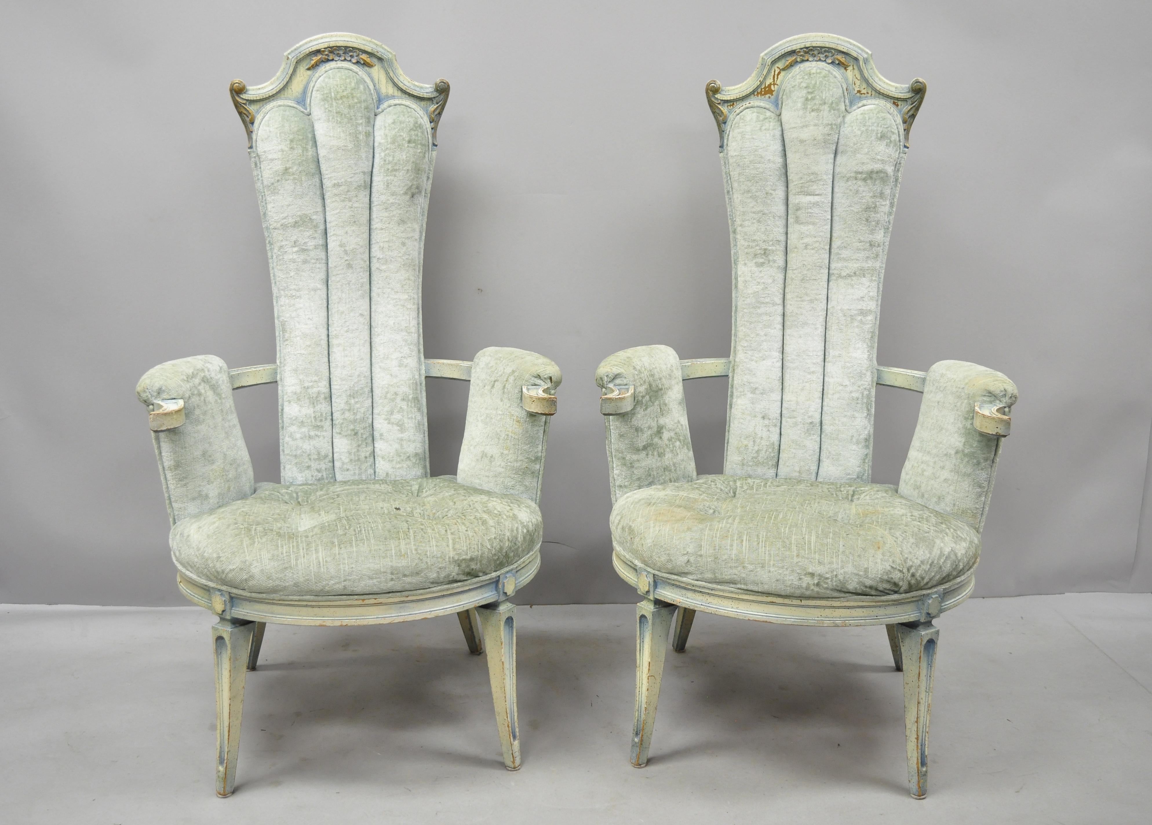 Pair of vintage high back Hollywood Regency style blue painted fireside armchairs. Items feature tall carved backs, blue distressed painted finish, solid wood construction, nicely carved details, quality American craftsmanship, sleek sculptural