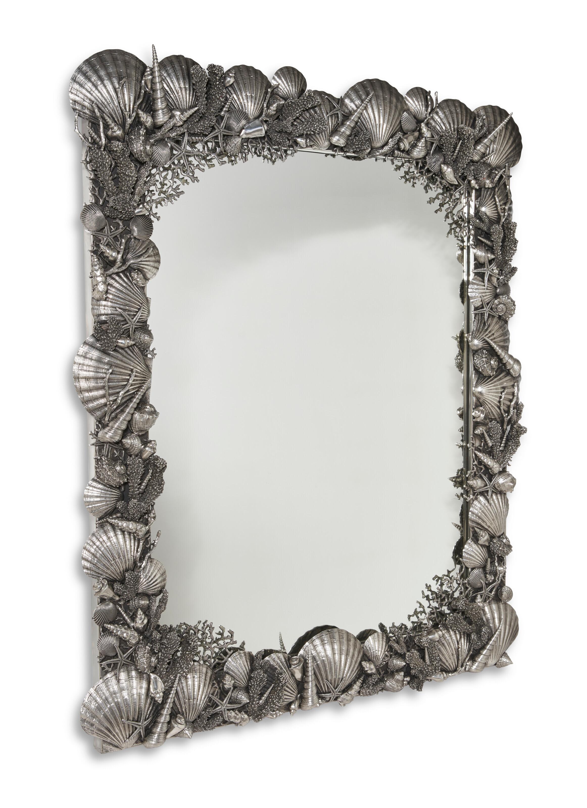 Our pair of vintage Italian made mirror with finely sculpted frame of three-dimensional sea shells each measure 34 1/2 by 41 inches and are in excellent condition.  Ideal for use as pier mirrors or to frame doorways.