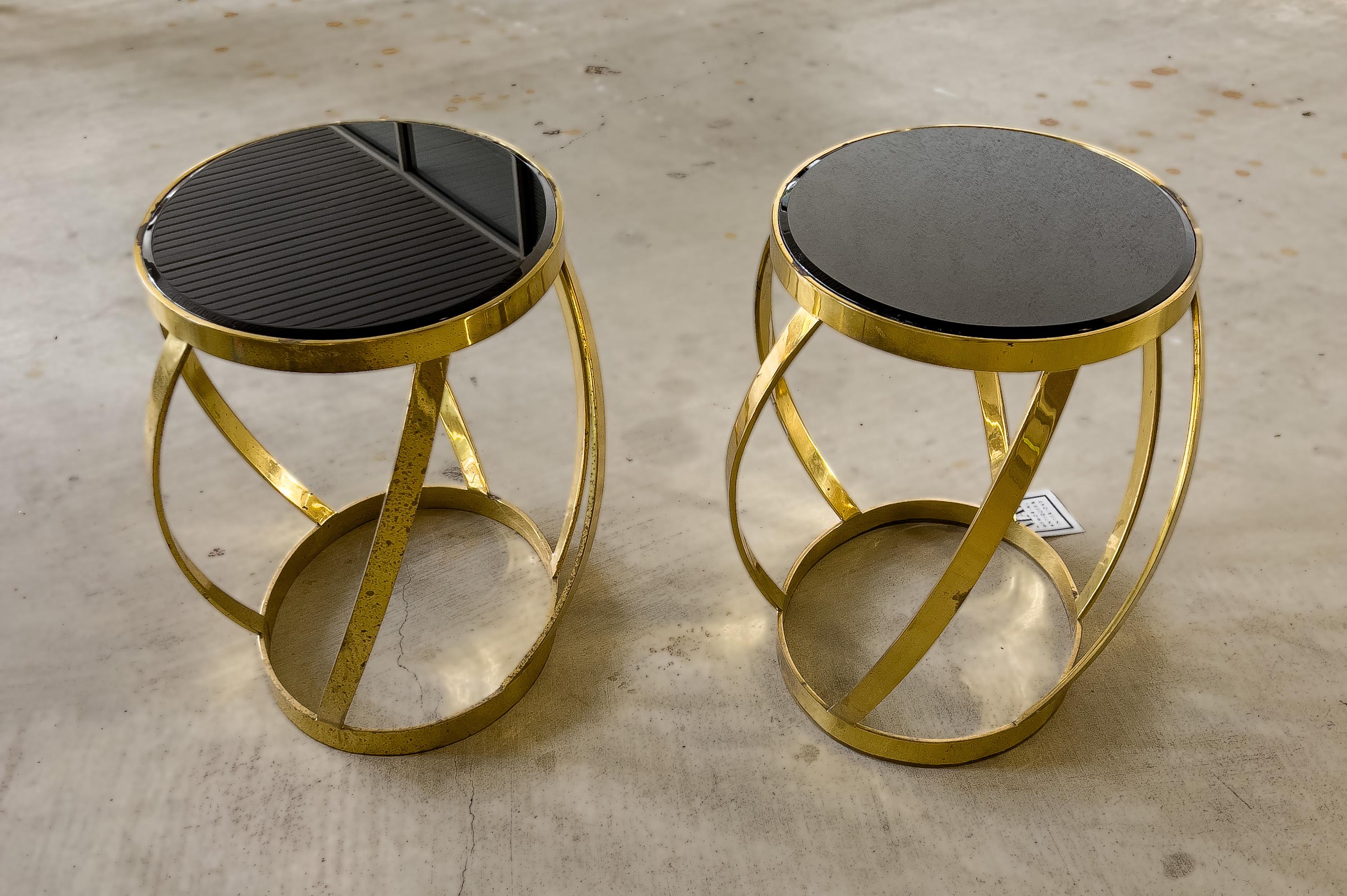 Pair of oval onyx and brass side tables by Karl Springer. Heavy brass table with an onyx beveled top.