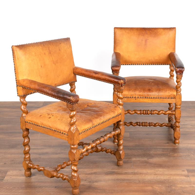 The enticing barley twist details of the frame combine with the rich patina of the vintage leather in a captivating manner in this pair of arm chairs. Take a close look at the detailed photos to appreciate the aged patina of the leather; typical