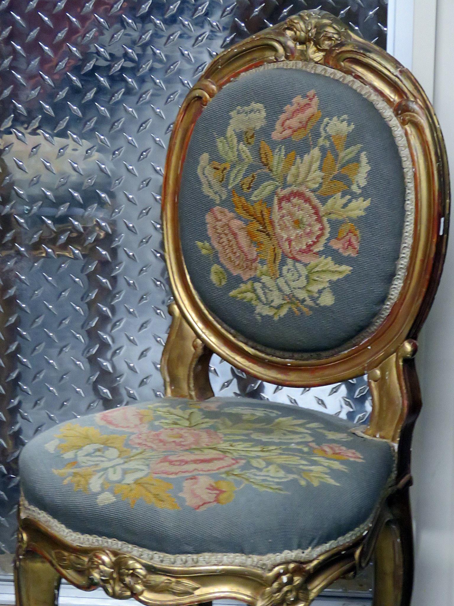Pair of vintage Gilded Louis XV style needlepoint upholstered side chairs with a distressed gilt finish frame.