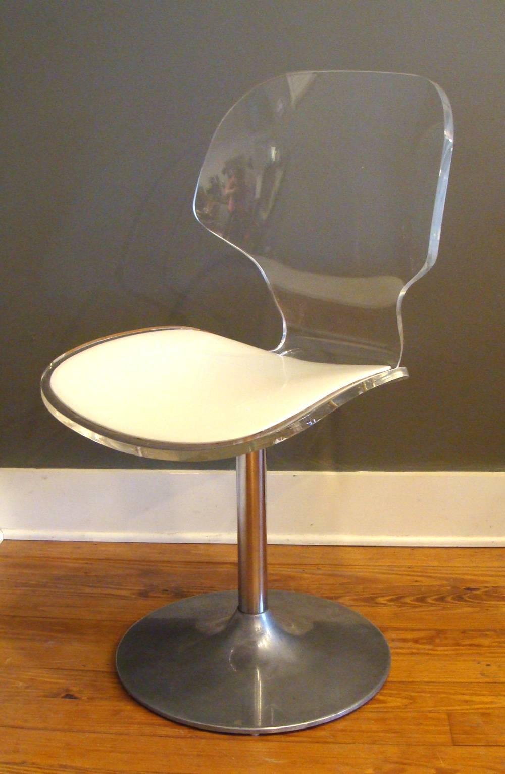 Matching pair of Lucite swivel chairs on pedestal base accompanied by matching table, all from Hill Mfg. Co. Chairs retain original white vinyl in good condition. Swivel works smoothly. Lucite is in beautiful condition.
Chairs are dining/desk