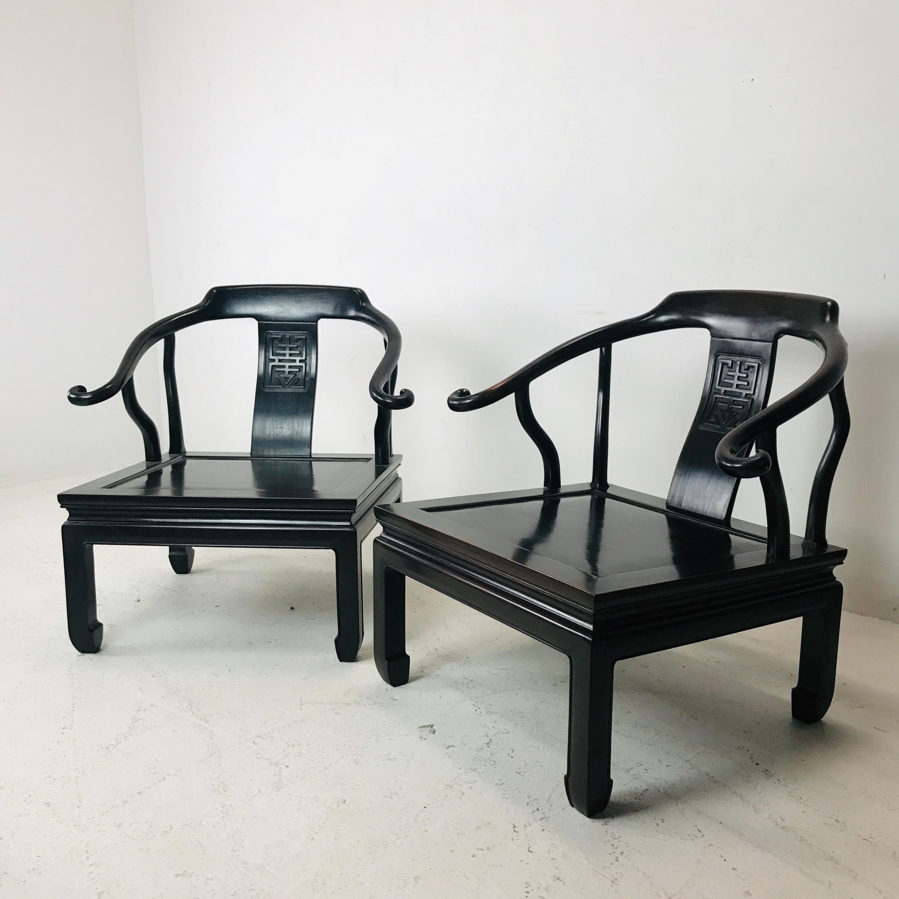 Pair of vintage Ming style rosewood chairs. Features quality solid construction, carved design details, made circa 1960s in Hong Kong. Dimensions: 28