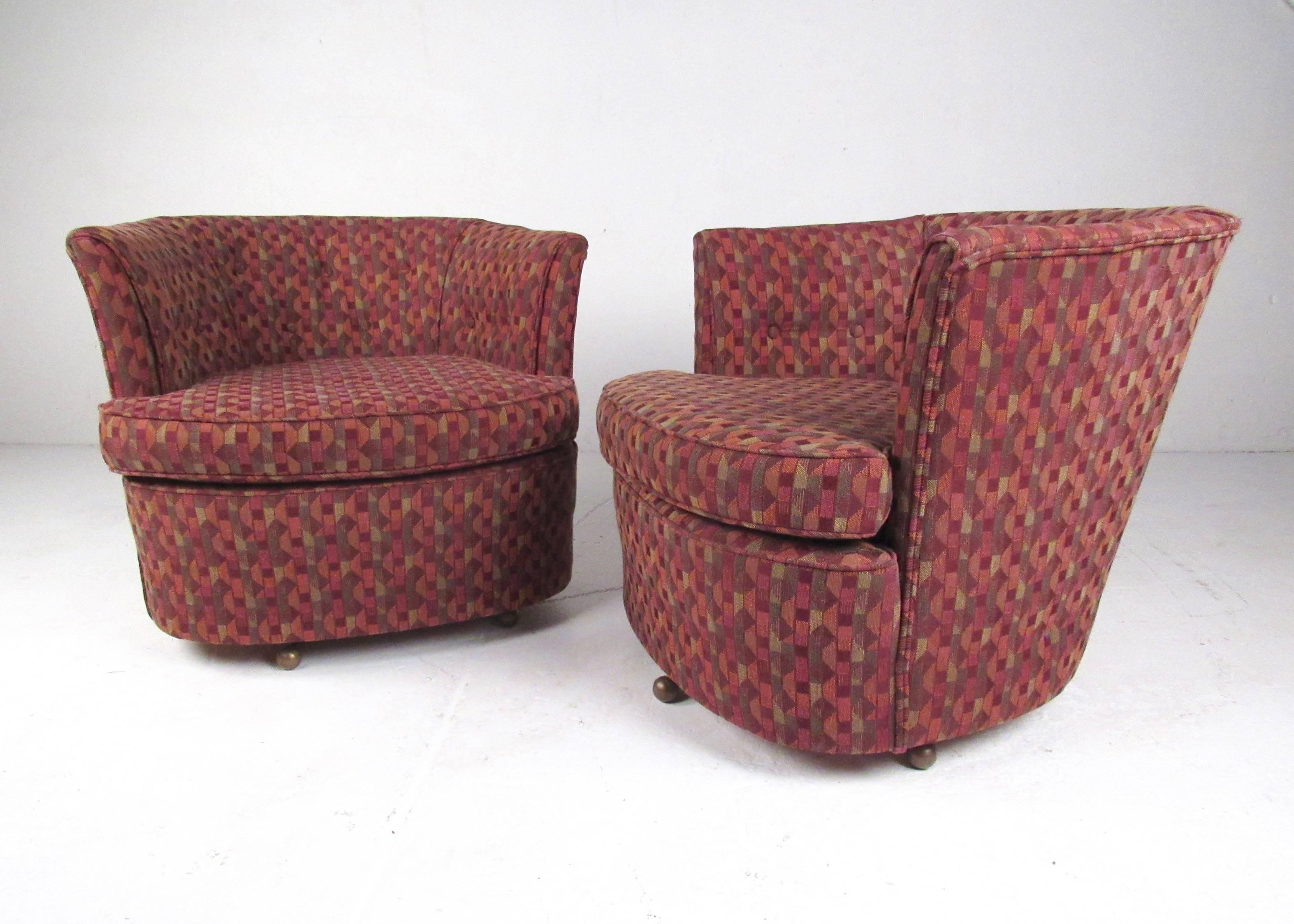This unique pair of swivel club chairs features new upholstery with stylish modern pattern. The chairs themselves are sturdy with even swivel and the unique vintage feet of the piece protrude from the base for a nice contrast in style, showcasing
