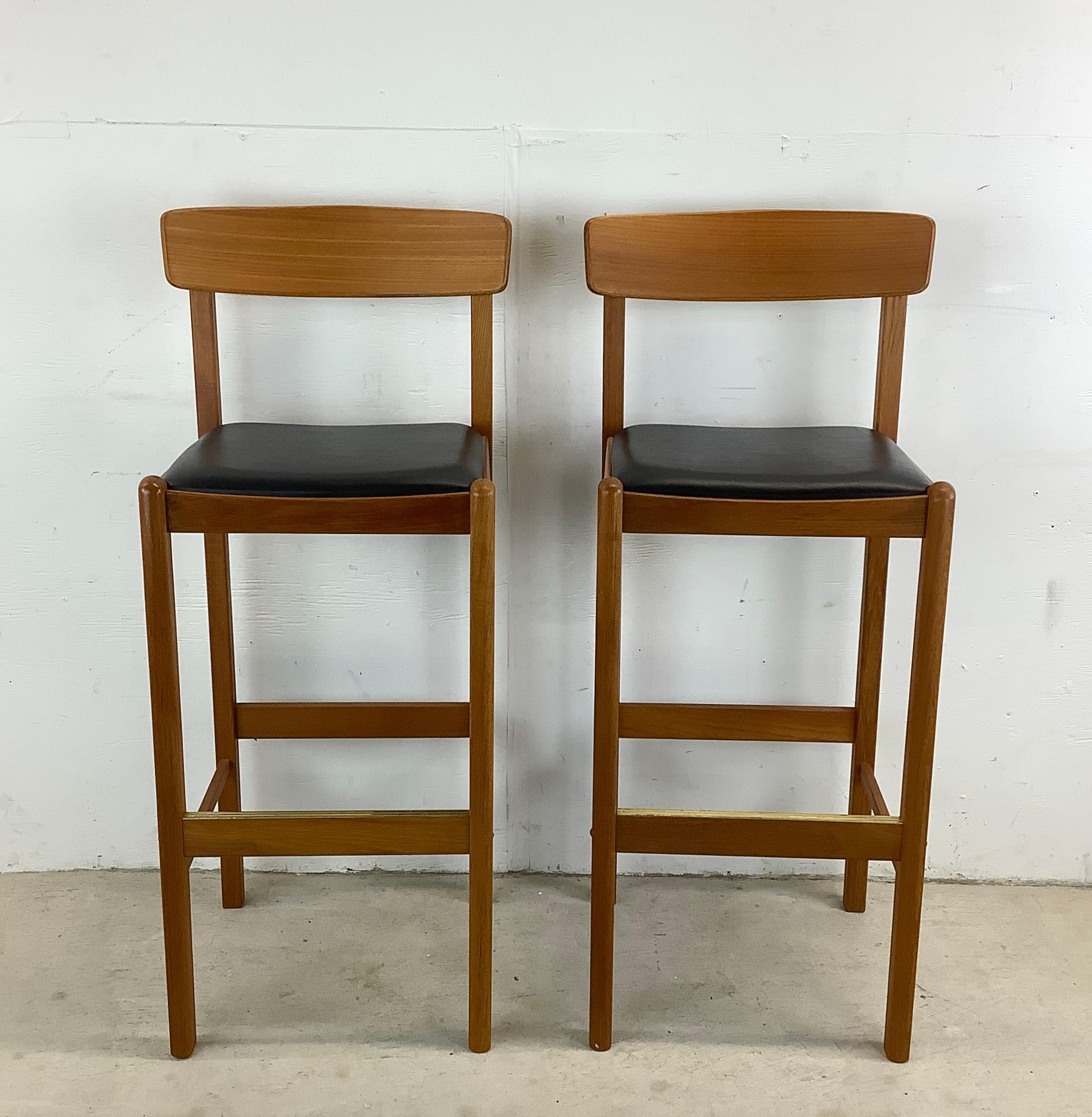 This Pair of Vintage Scandinavian Style Teak Bar Stools from Benny Linden are the epitome of sleek sophistication and timeless design. Inspired by Danish Modern craftsmanship these bar stools are not just seating options; they're statements of