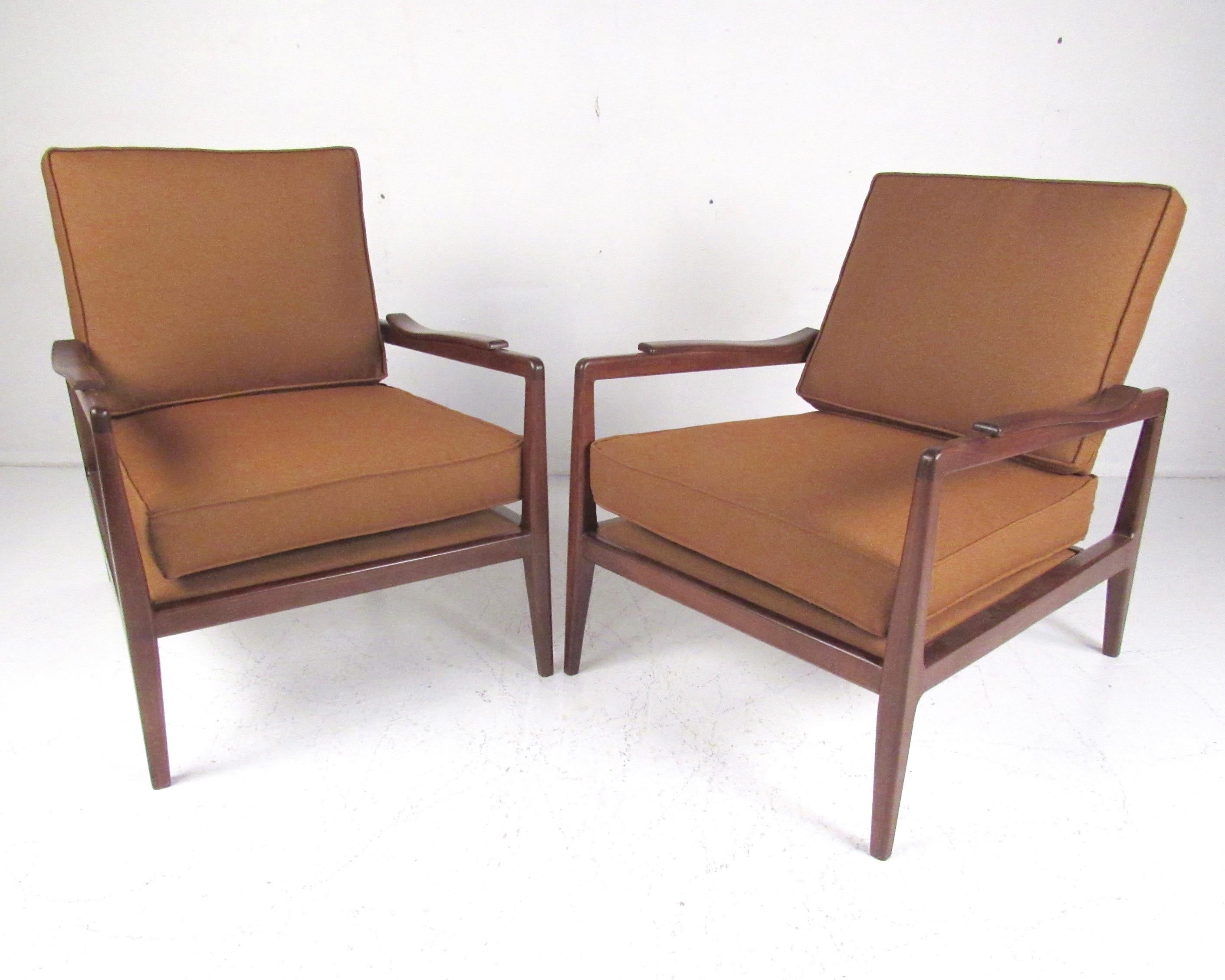 This striking pair of low profile vintage modern lounge chairs feature sculptural spindle seat backs, wide comfortable seats, and uniquely curved armrests. Designed by Edmond Spence for Urban-Aire. The impressive Mid-Century Modern design of this