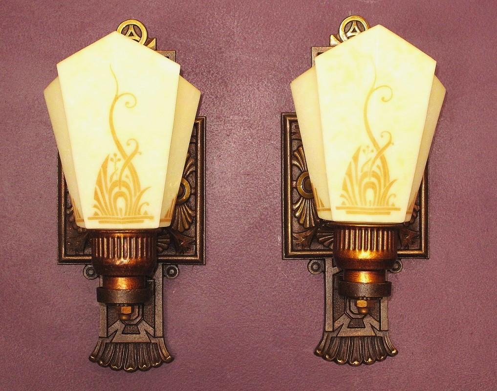 Priced per pair with more than 2 possibly available.
Slip Shade wall sconces signed Moe Bridges on back. The Swan was one of Moe Bridges Co trademark designs. Stylized flowing lines on shade mimic both the Swan's feathers as well as the pond side