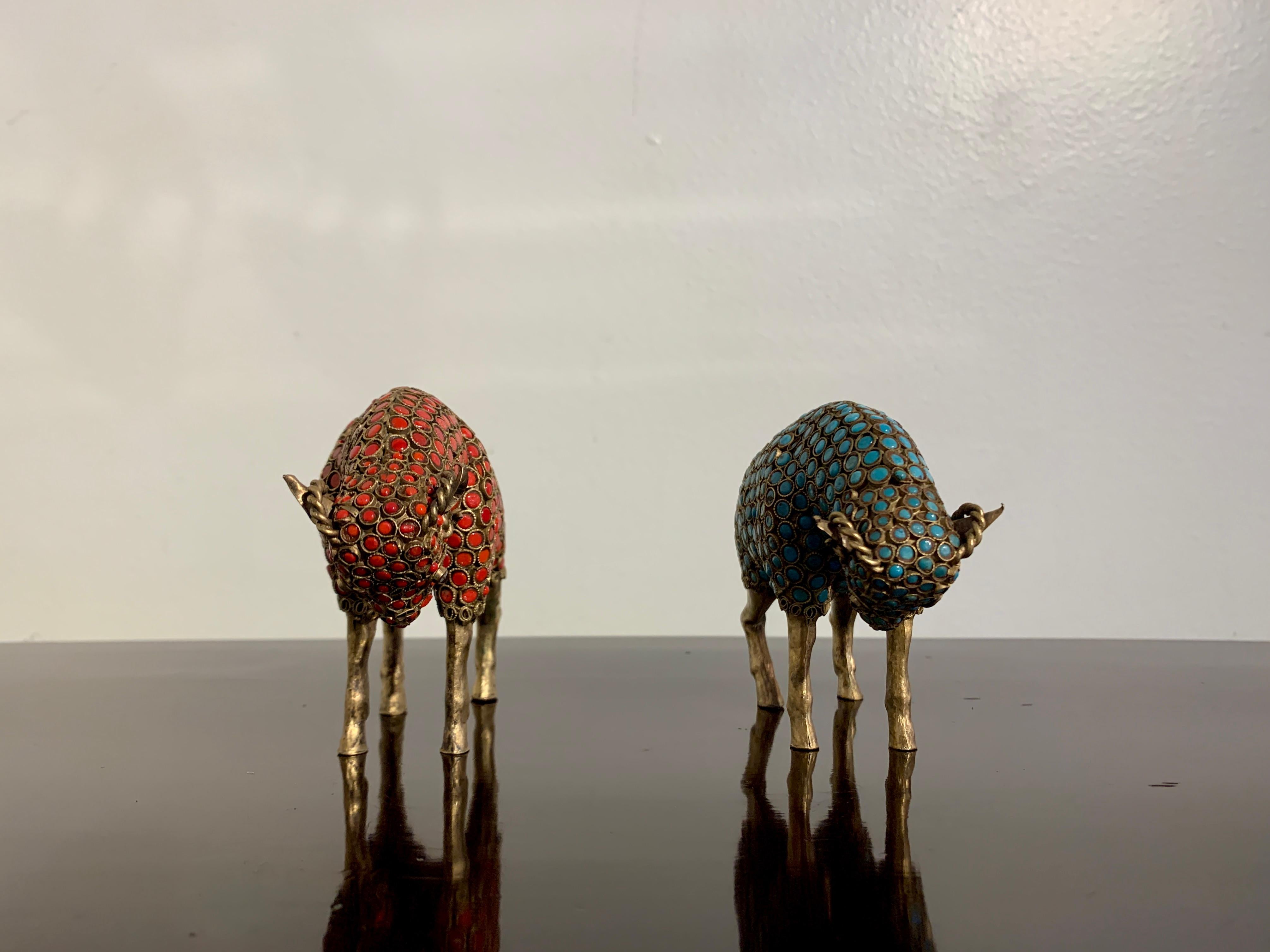 A pair of wonderful vintage Nepalese handicraft figures of confronting rams, brass sheet and wire, with glass bead inlays imitating coral and turquoise, circa 1970's, 

The rams portrayed with their heads down as if preparing to headbutt one