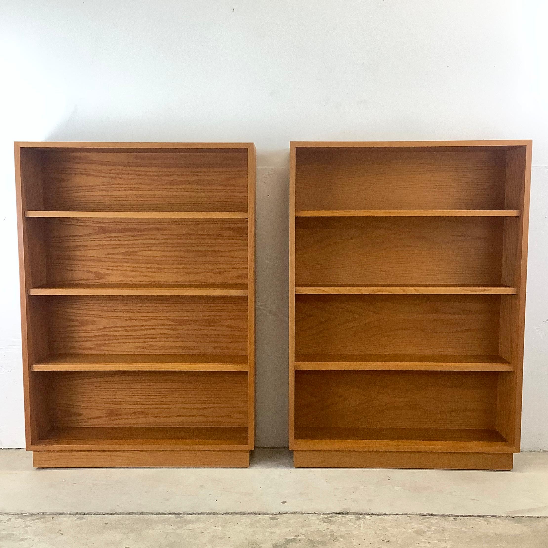 Introducing this pair of simple yet striking four-shelf oak bookcases, crafted to embody the classic appeal and timeless design of mid-century danish furniture. These bookcases, in a rich vintage wood finish, offer both beauty and practicality,