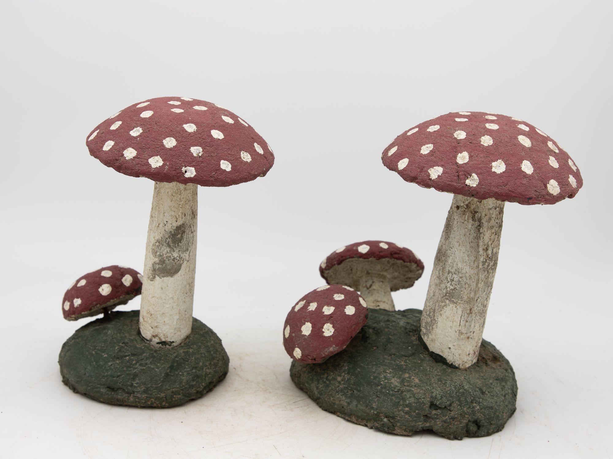 This charming pair of vintage painted stone toadstools hails from mid-20th century Belgium, epitomizing whimsical garden decor. Standing tall with painted red caps adorned with white spots, they exude a playful, fairytale-like allure. Crafted from