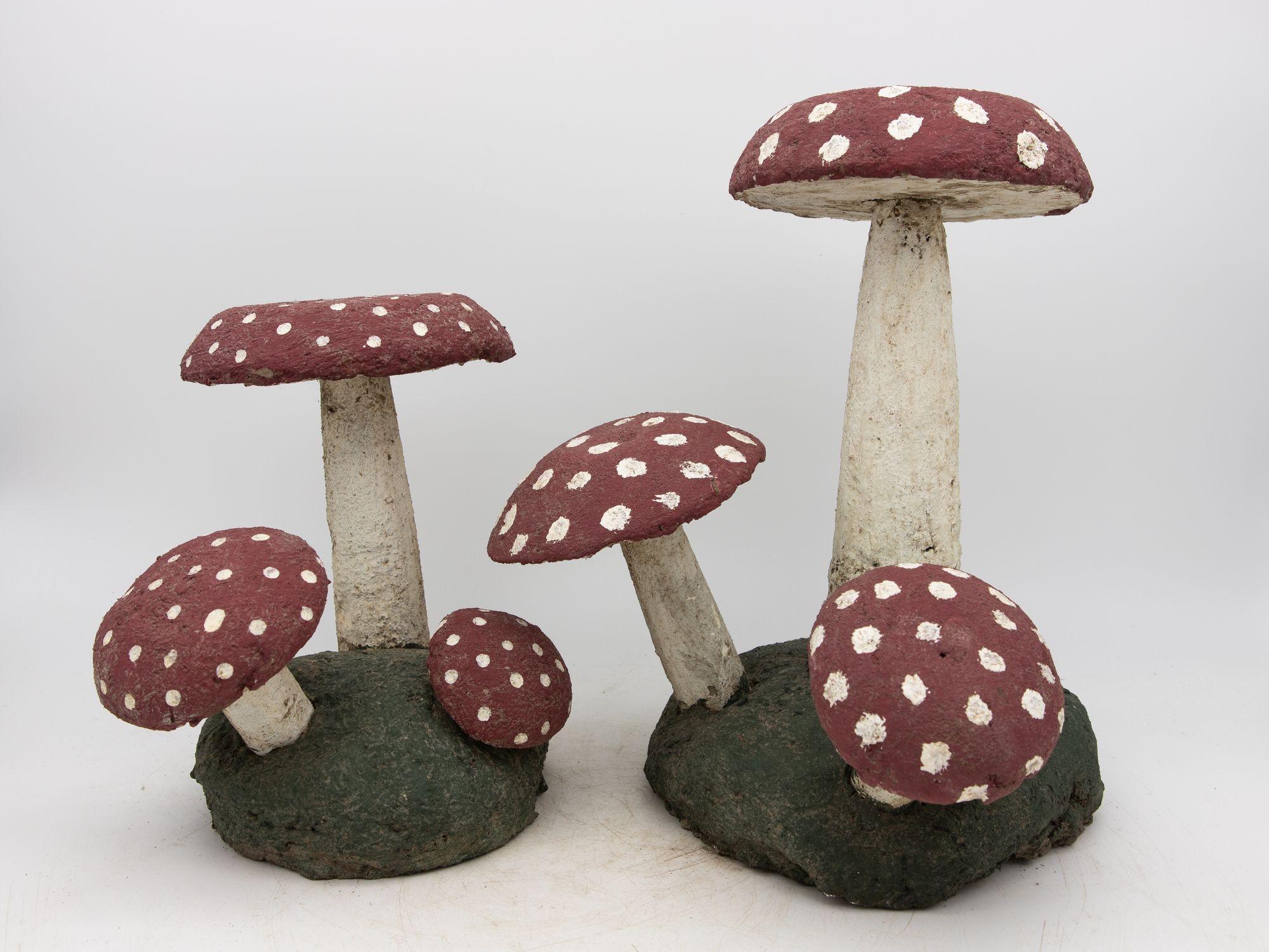 This charming pair of vintage painted stone toadstools hails from mid-20th century Belgium, epitomizing whimsical garden decor. Standing tall with painted red caps adorned with white spots, they exude a playful, fairytale-like allure. Crafted from