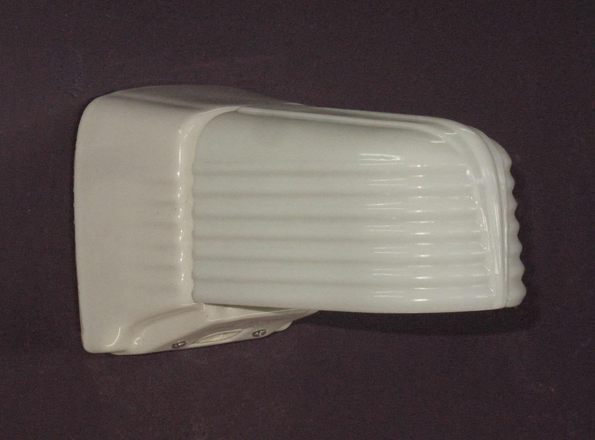 Priced for one pair with another similar pair also available.
These sconces are in excellent condition with no noticeable chips and no cracks. Interesting design with no visible means of attaching the shade or mounting the back plate from the