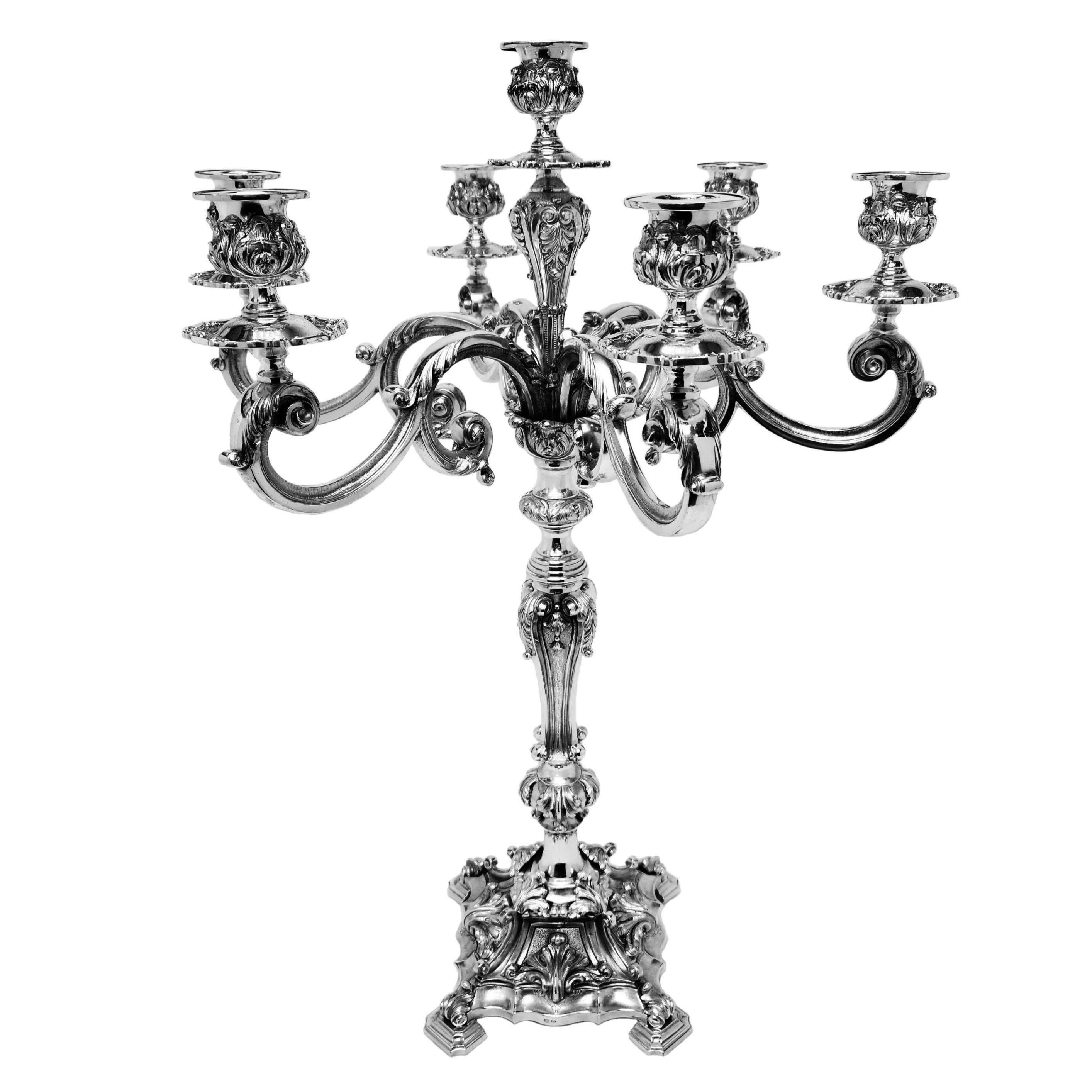 A pair of magnificent vintage Silver Candelabra with 6 acanthus leaf embellished branches around a central candleholder. The Candelabra each stand on shaped square bases decorated with shell and scroll designs and standing on four feet.

Made in