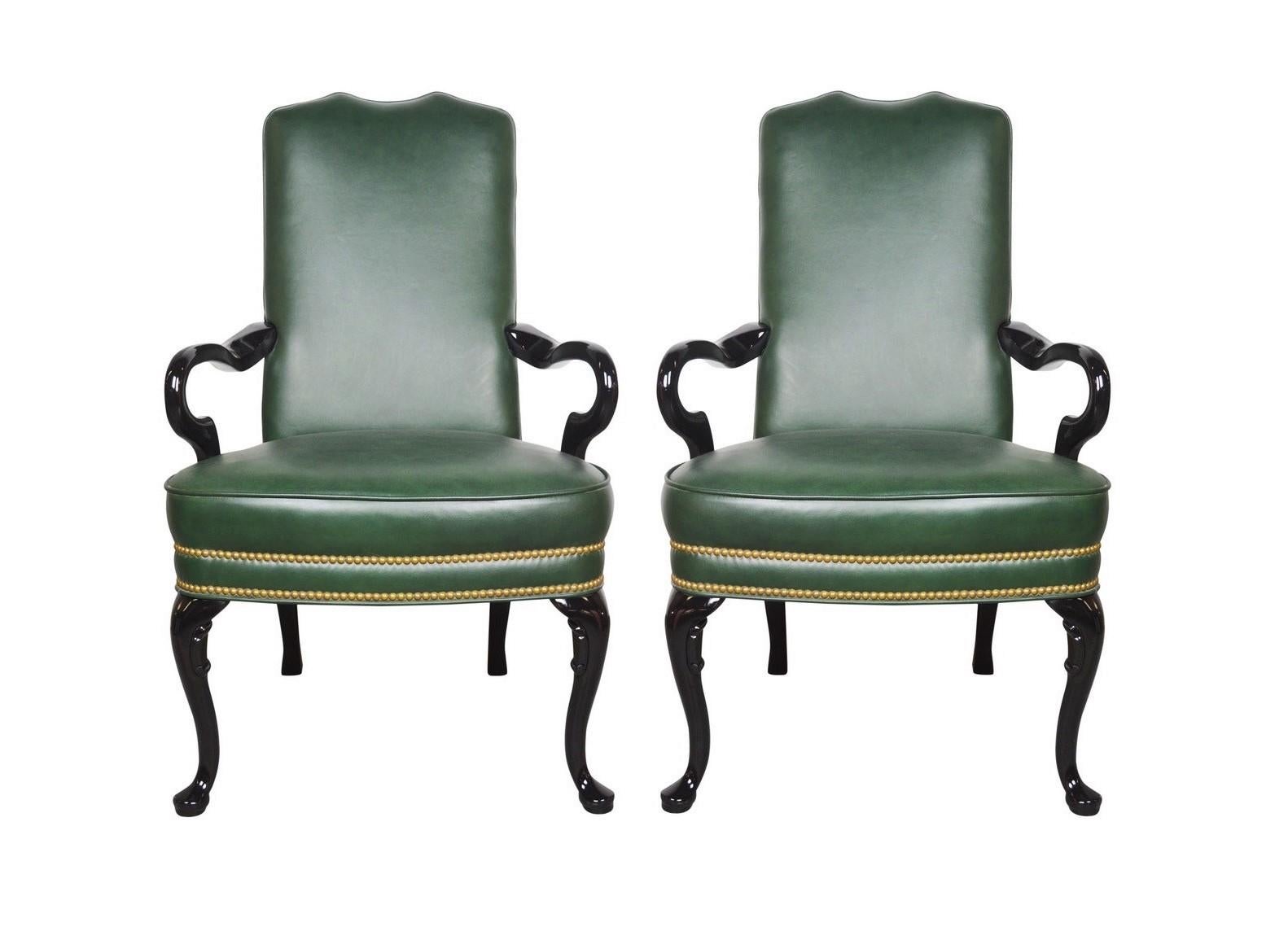 Pair of lovely vintage Queen Anne style library chairs. The chairs feature beautiful green upholstery with brass nail head trim, arms and legs in a very nice lacquered finish. Great silhouette with a yoke crest above a padded high back and seat